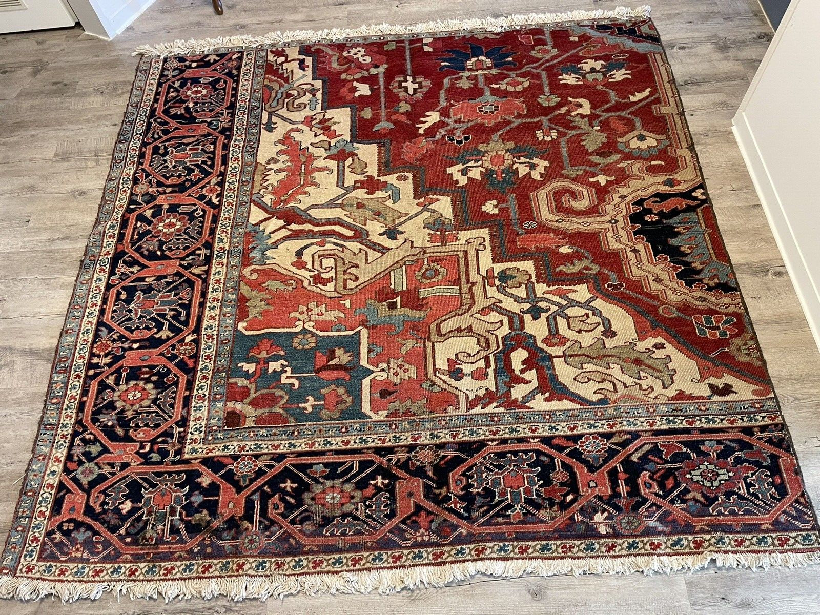 Close-up of a corner spandrel of the rug, highlighting the intricate geometric patterns and the use of multiple colors to create depth and visual interest.