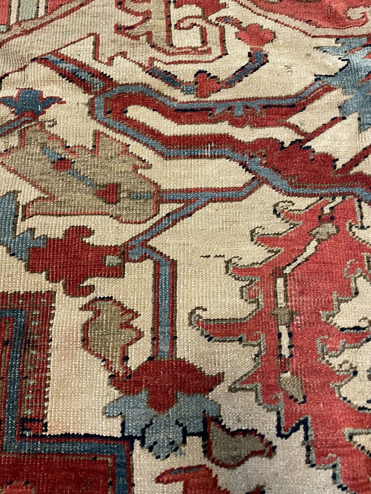 A close-up view of the fringe along one edge of the rug, revealing the natural wool fibers and the traditional finishing technique.