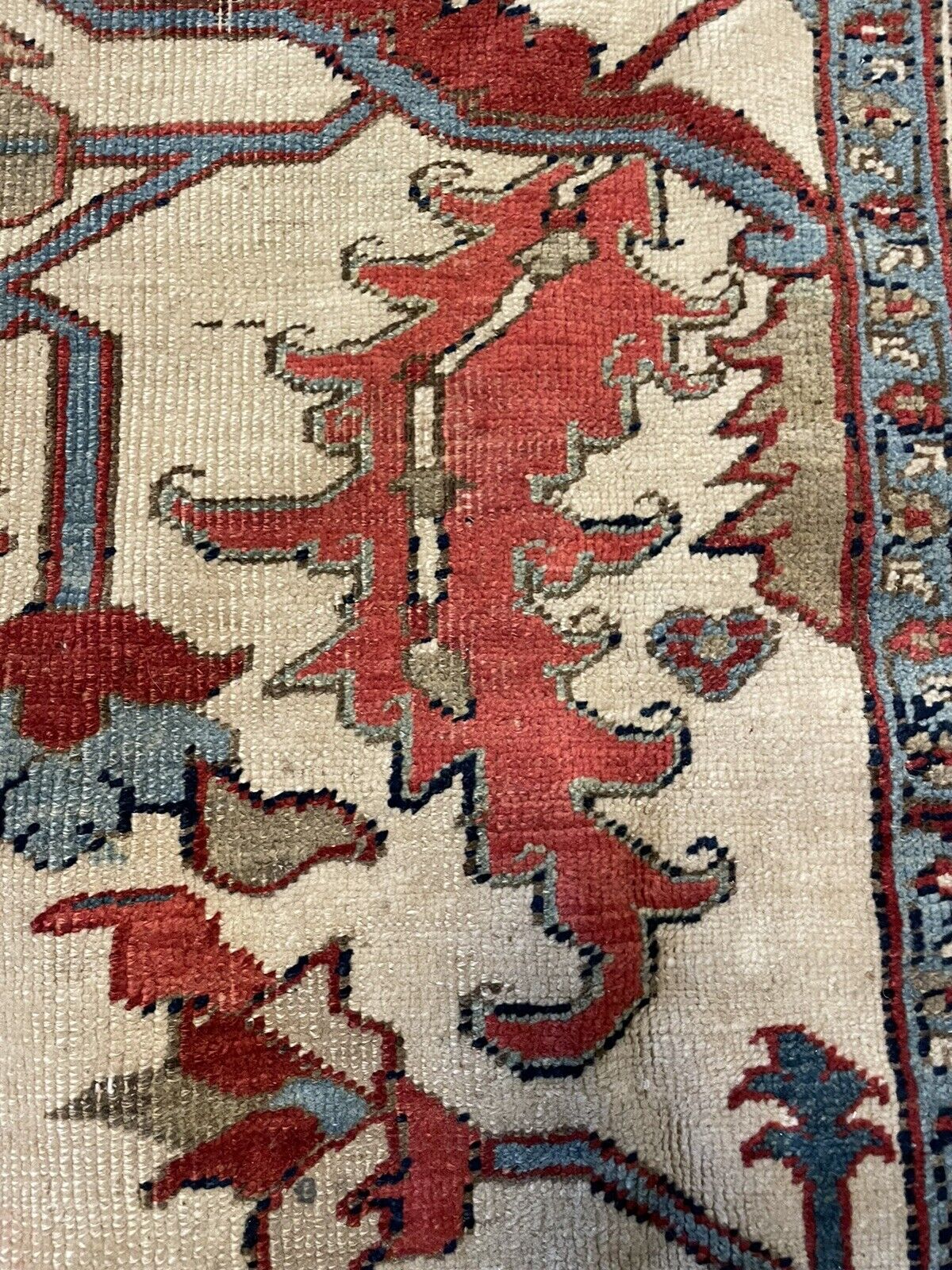 A detailed image of the rug's pile height, showcasing the soft, medium wool texture and the overall good condition despite its age.