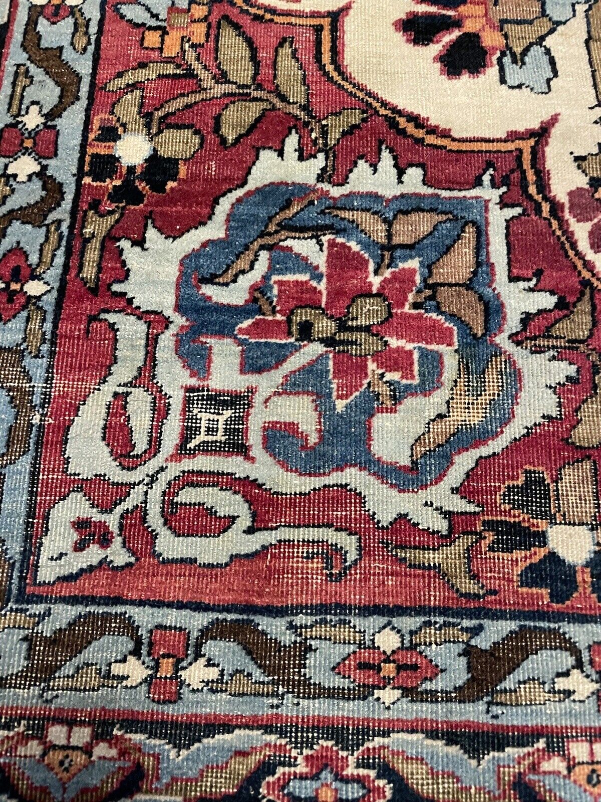 Aged wool Kerman Lavar rug with elegant floral motifs
