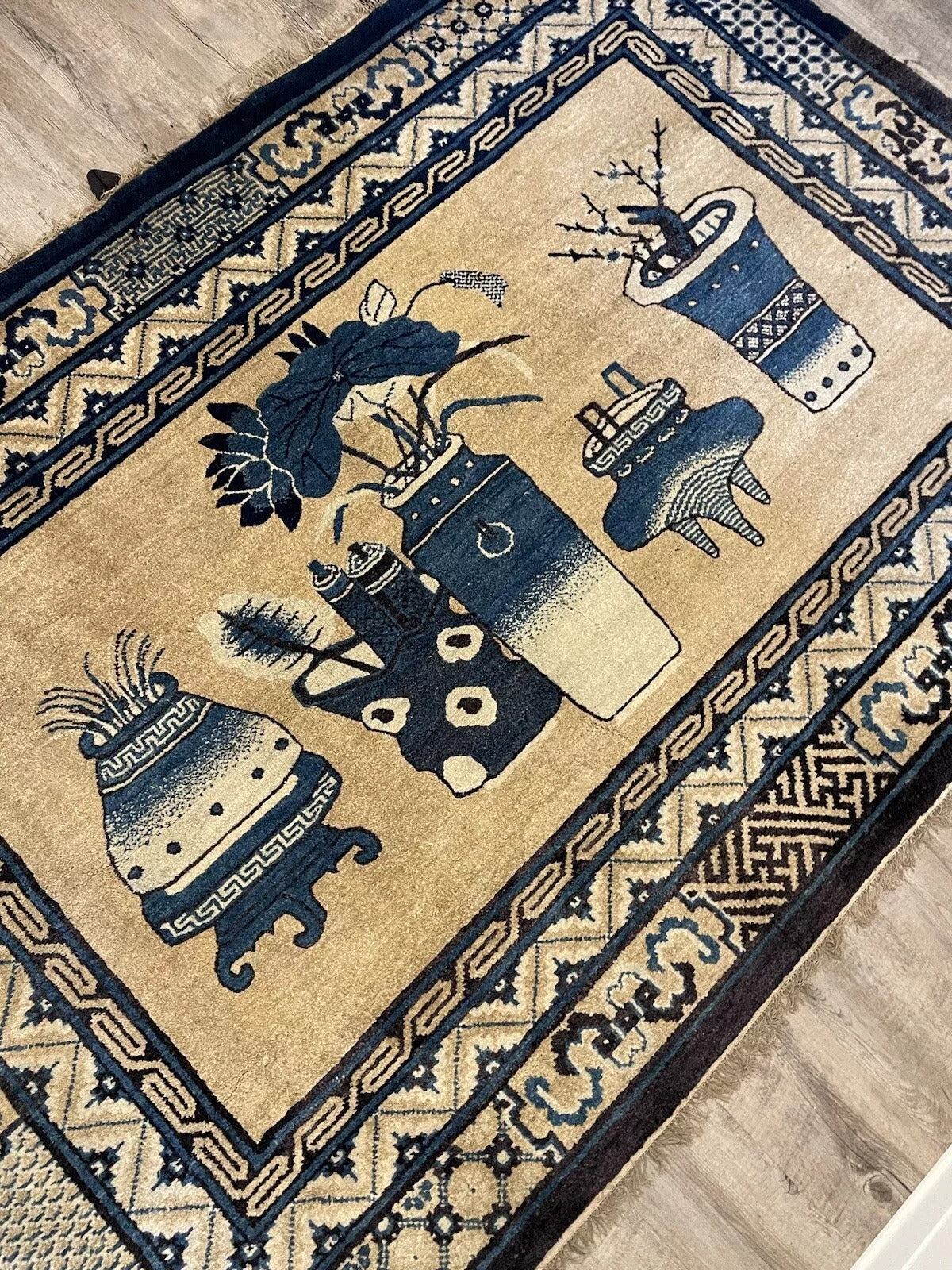 Close-up of intricate floral motifs on a Peking wool rug
