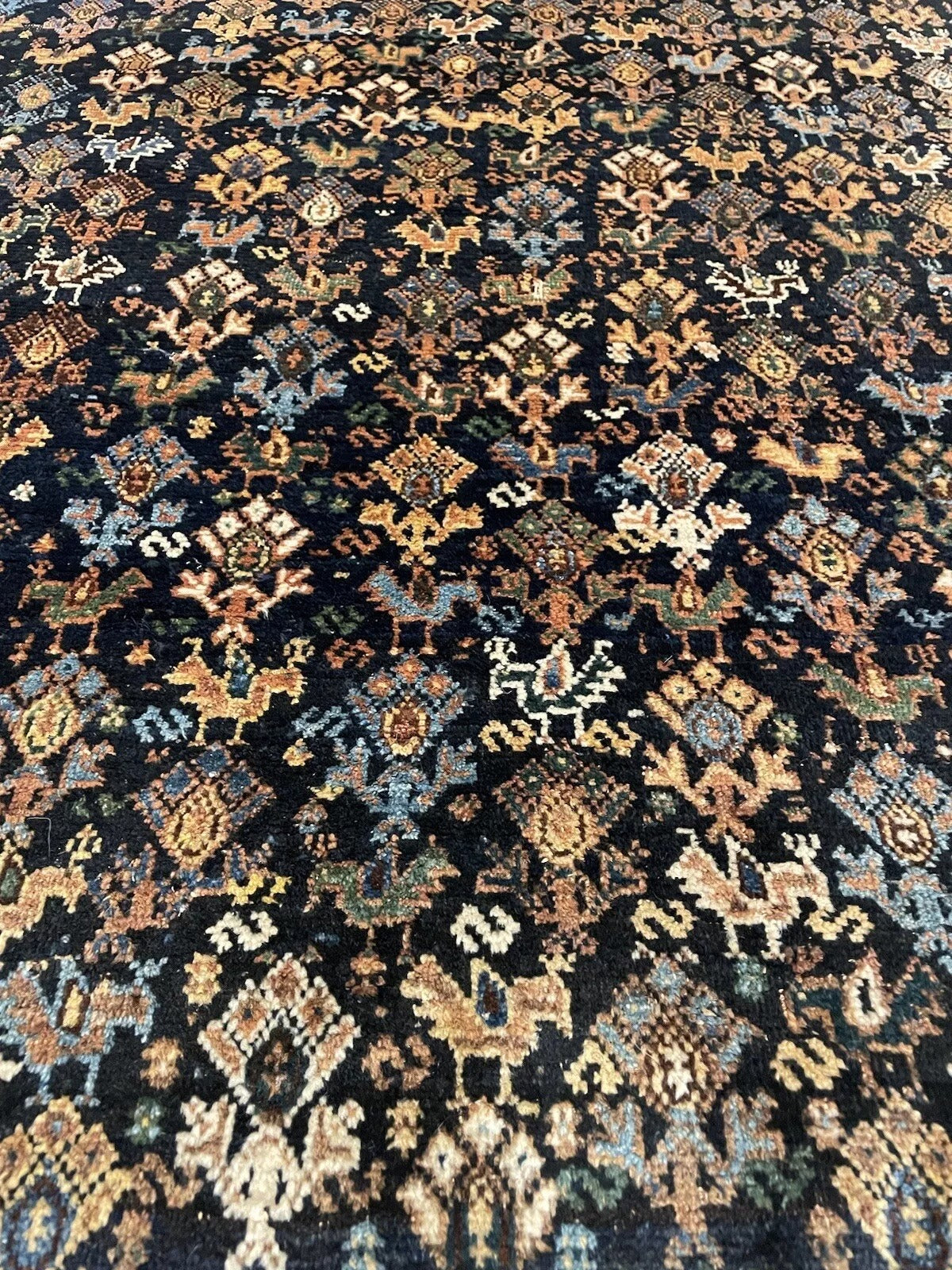 Rich brown, black, and beige tones in a handwoven antique rug
