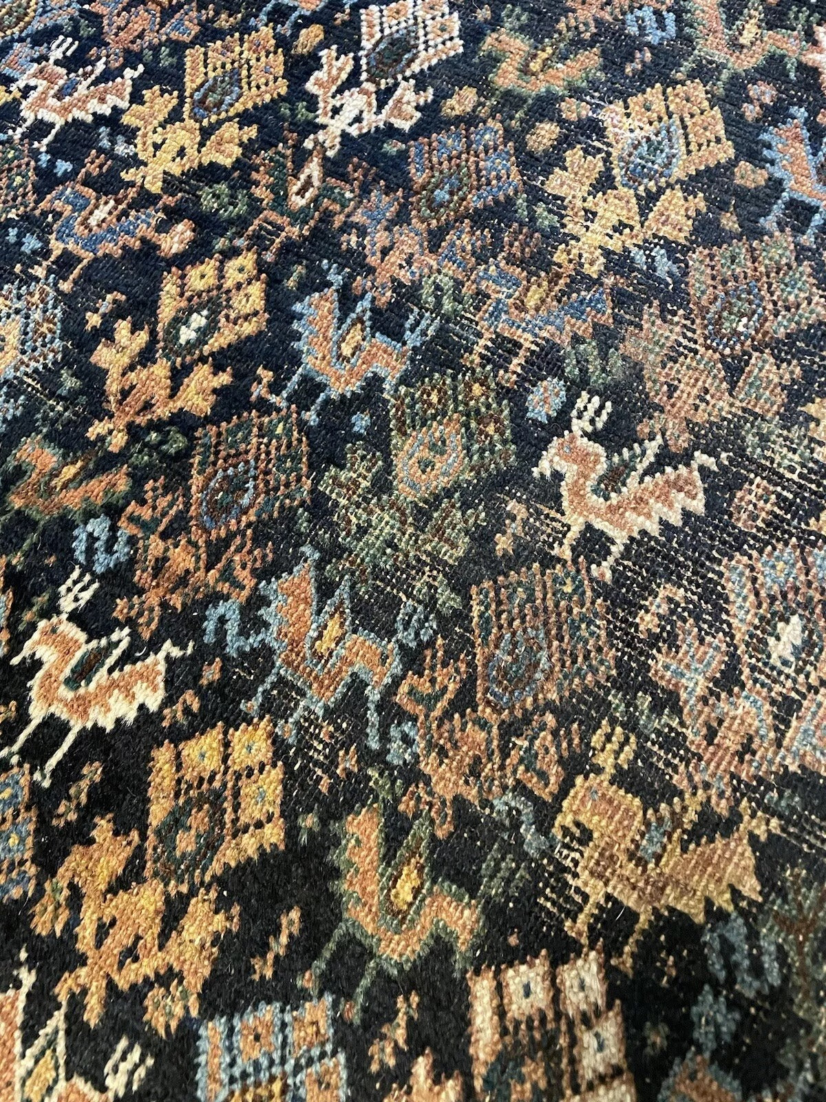 Traditional handmade Middle Eastern rug with decorative elements
