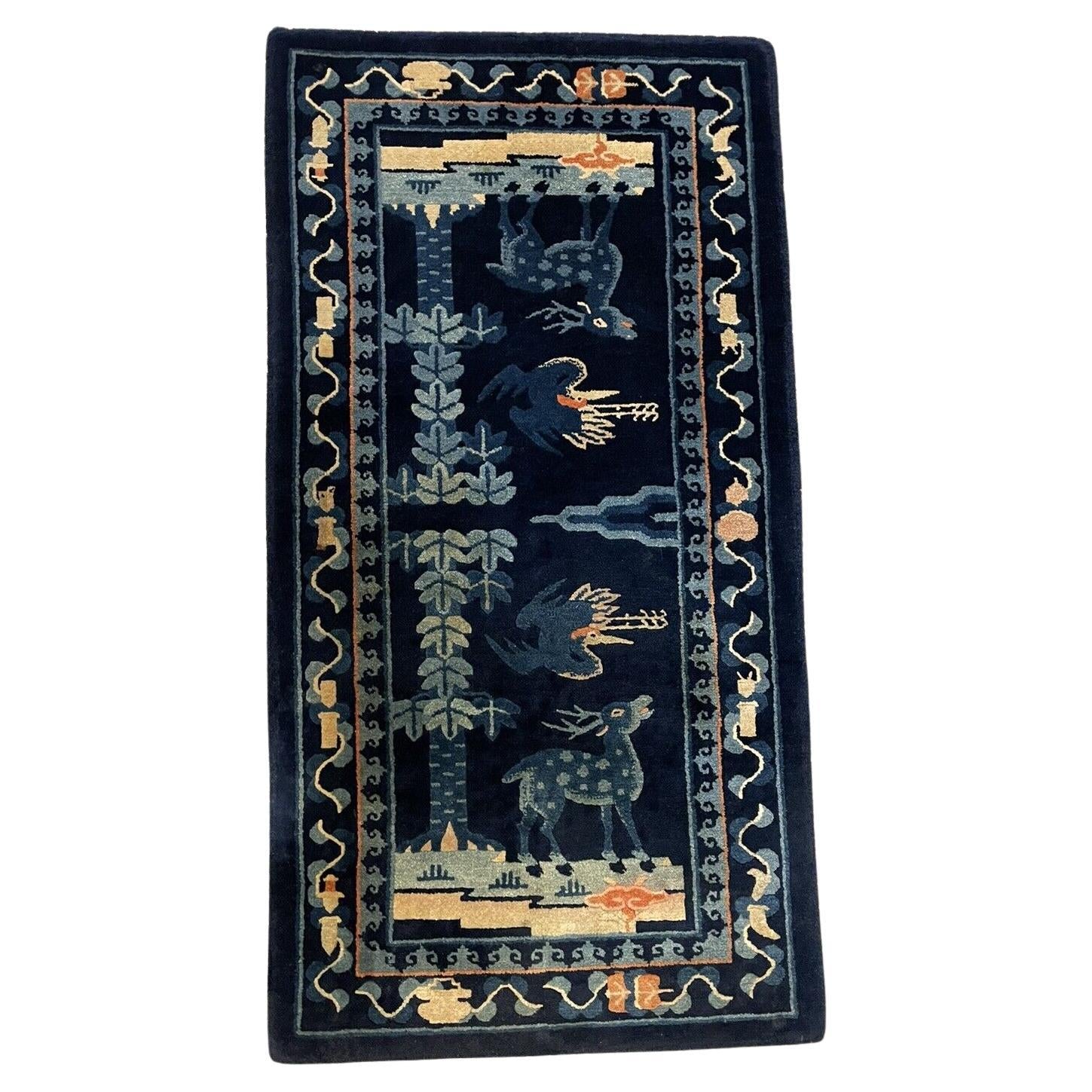 Handmade antique Peking Chinese rug with deer and bird motifs

