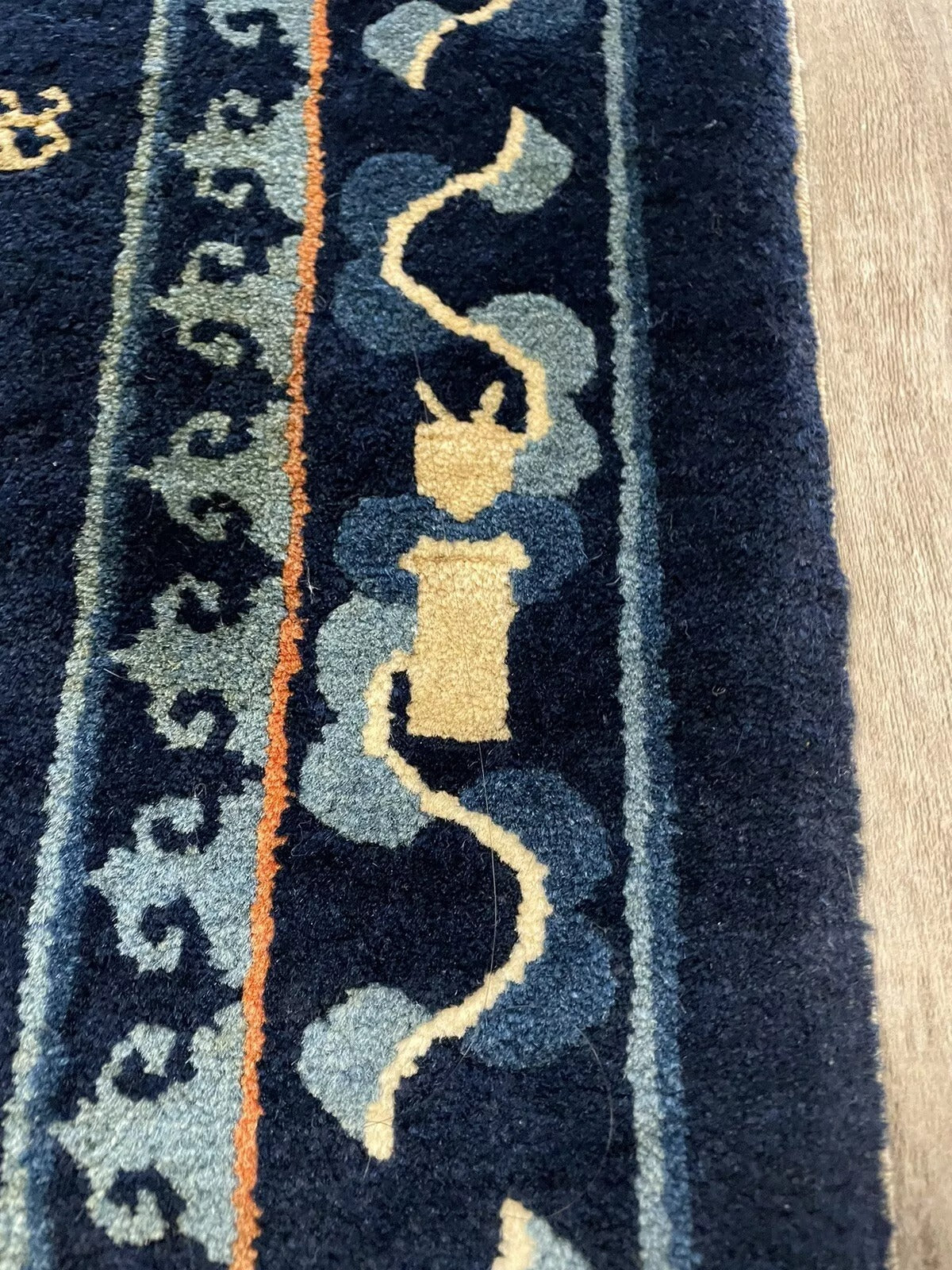Intricate wool rug with traditional Chinese motifs and nature scenes
