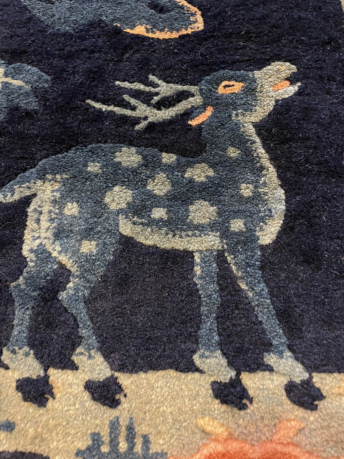 Decorative handmade Chinese rug with beige and soft orange accents
