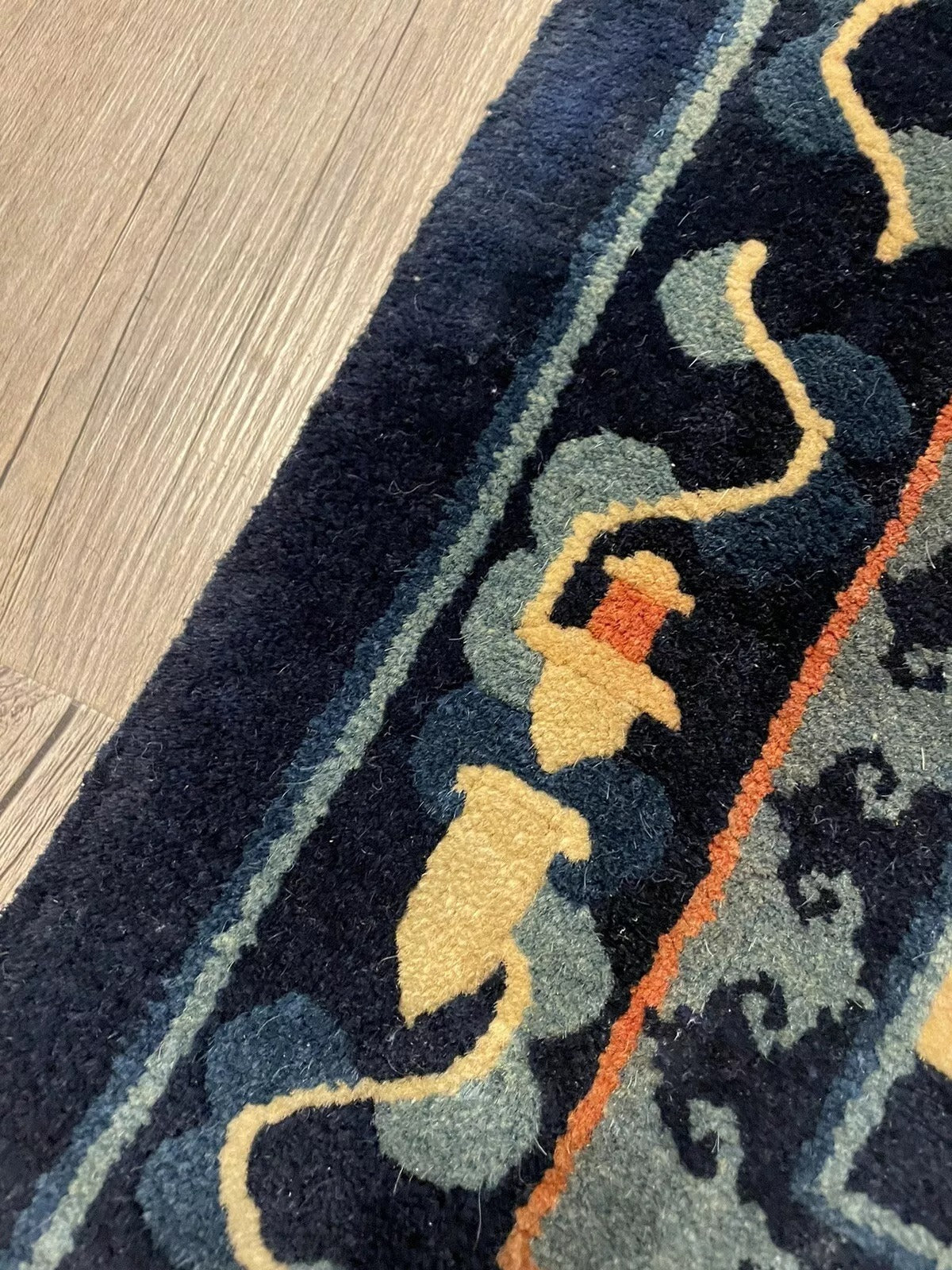 Close-up of fine wool craftsmanship in a 1900s Oriental rug
