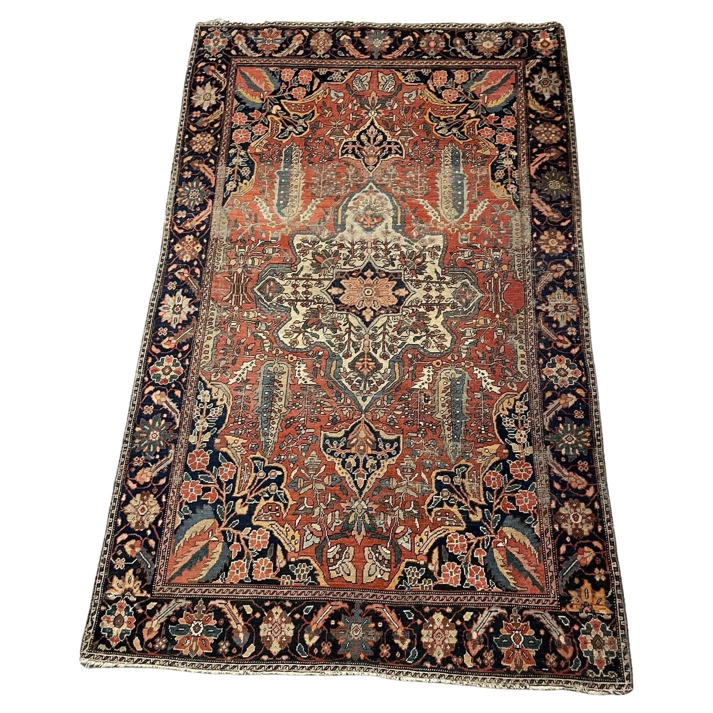 Handmade antique Persian Farahan wool rug from the 1870s
