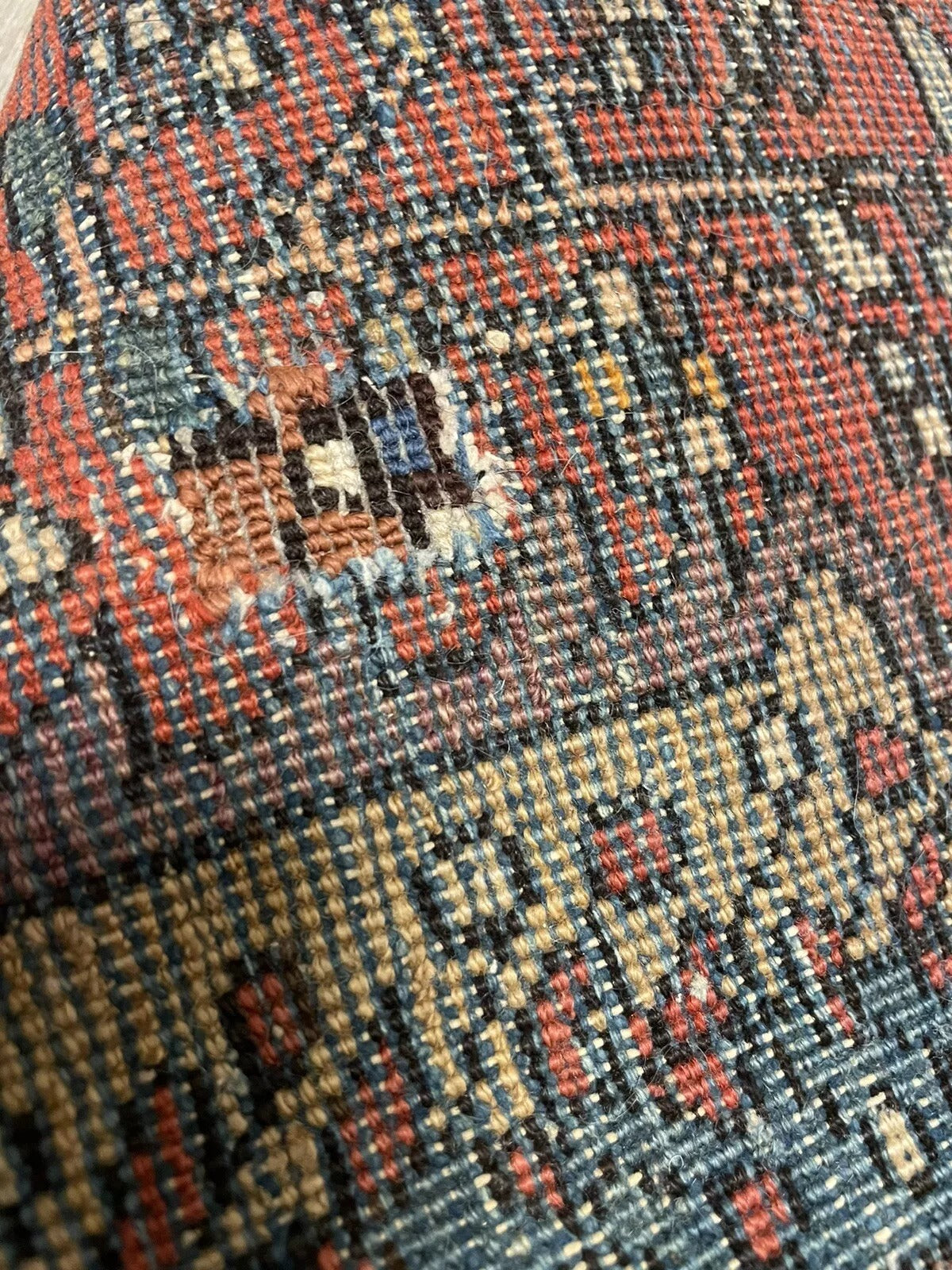 Handwoven Persian rug with unique distressed texture
