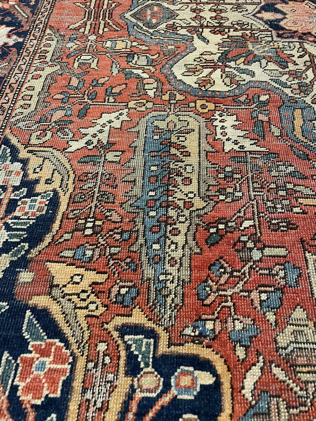 Red and blue antique Farahan rug with delicate beige details

