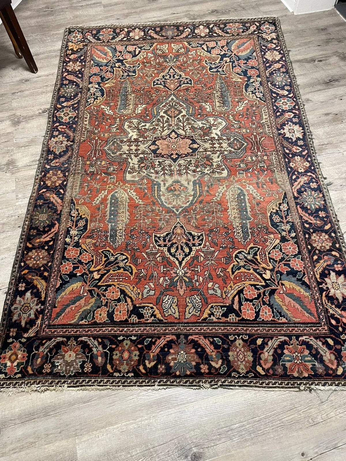 A timeless antique Persian Farahan rug with muted aged hues
