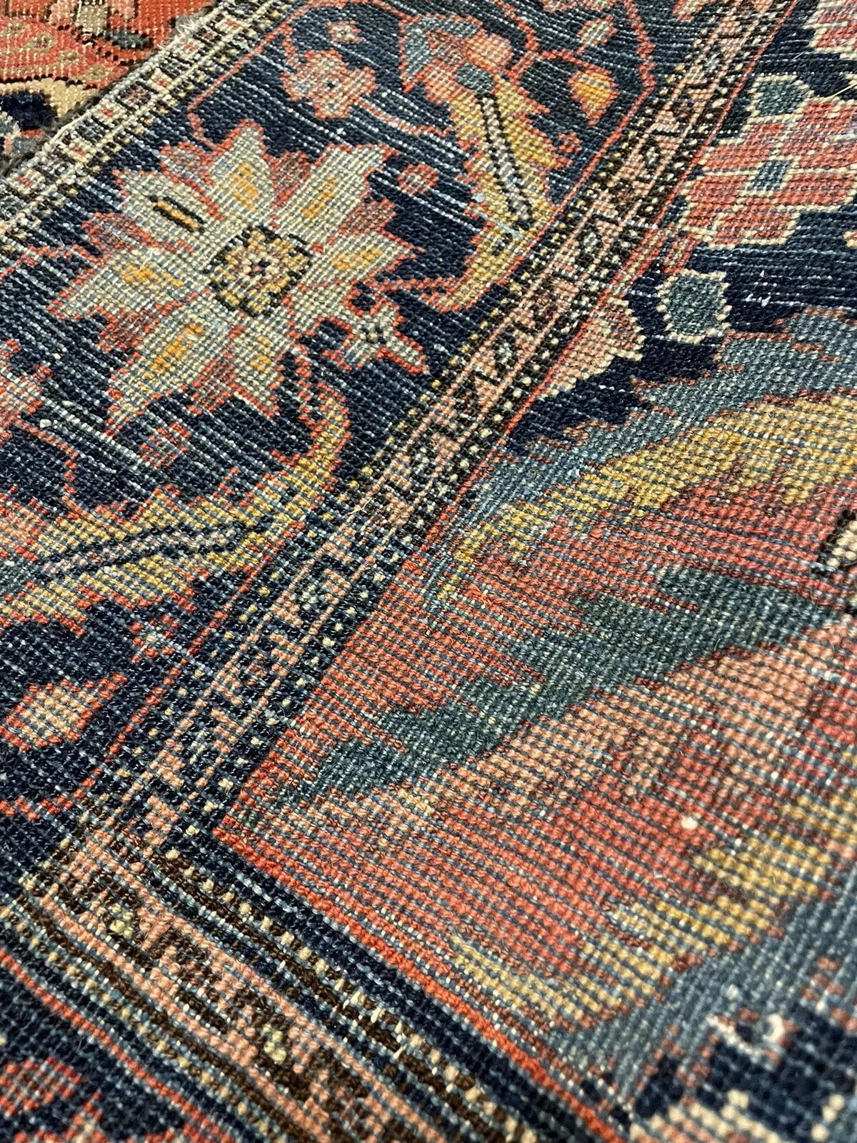 Low pile Persian wool rug with floral and geometric patterns
