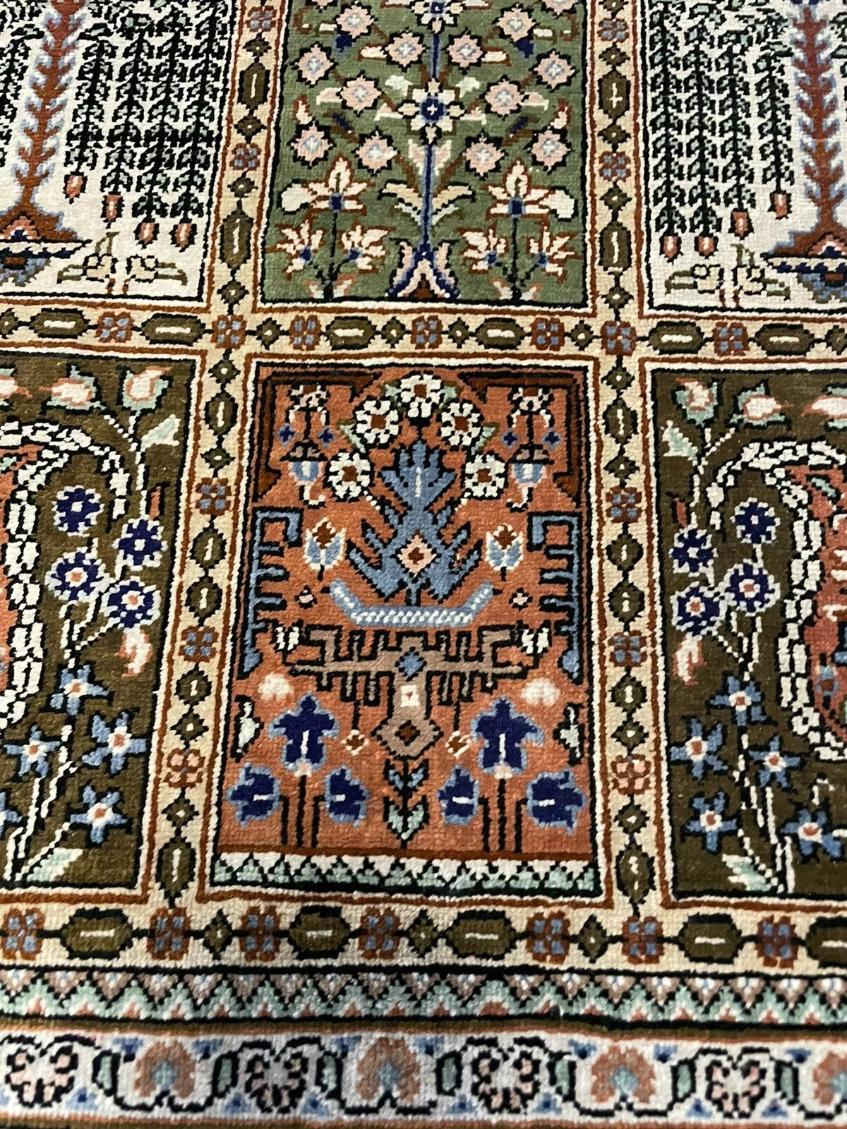 Close-up of the Persian Qum rug’s detailed floral patterns
