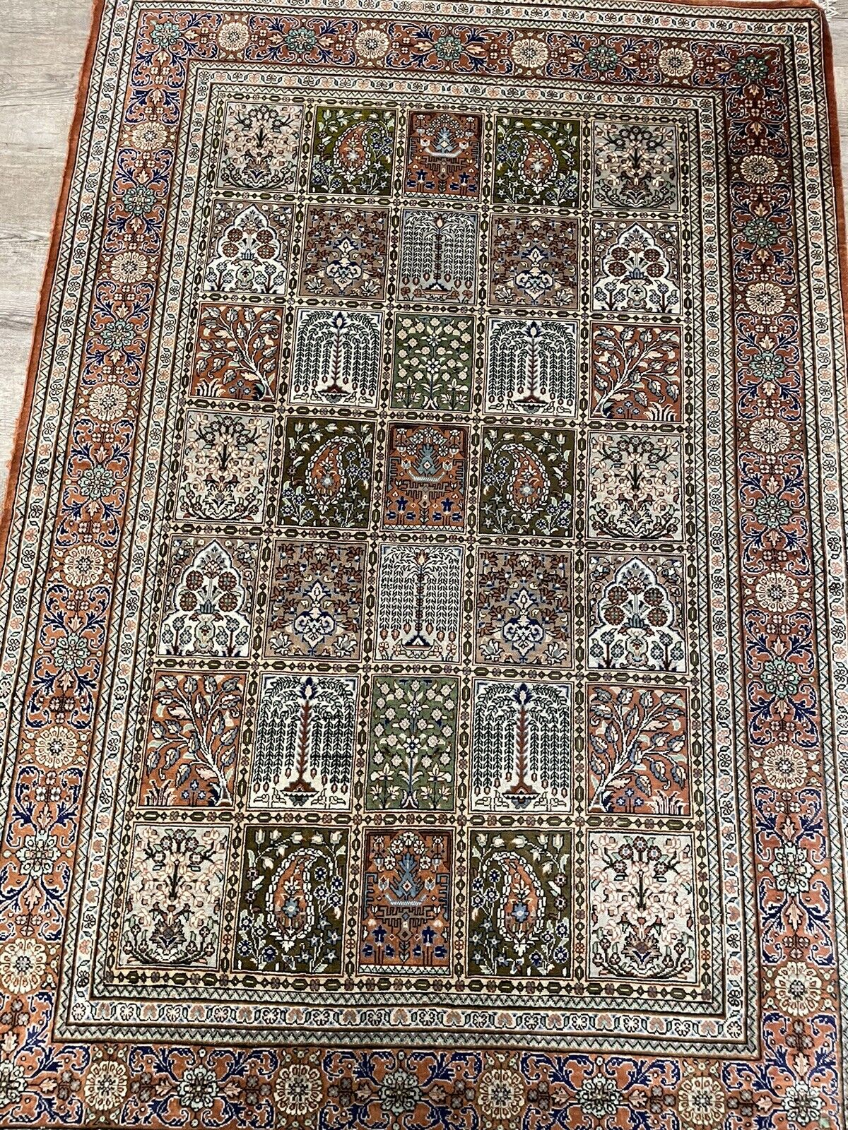 A beautifully woven Persian silk rug with delicate fringe edges
