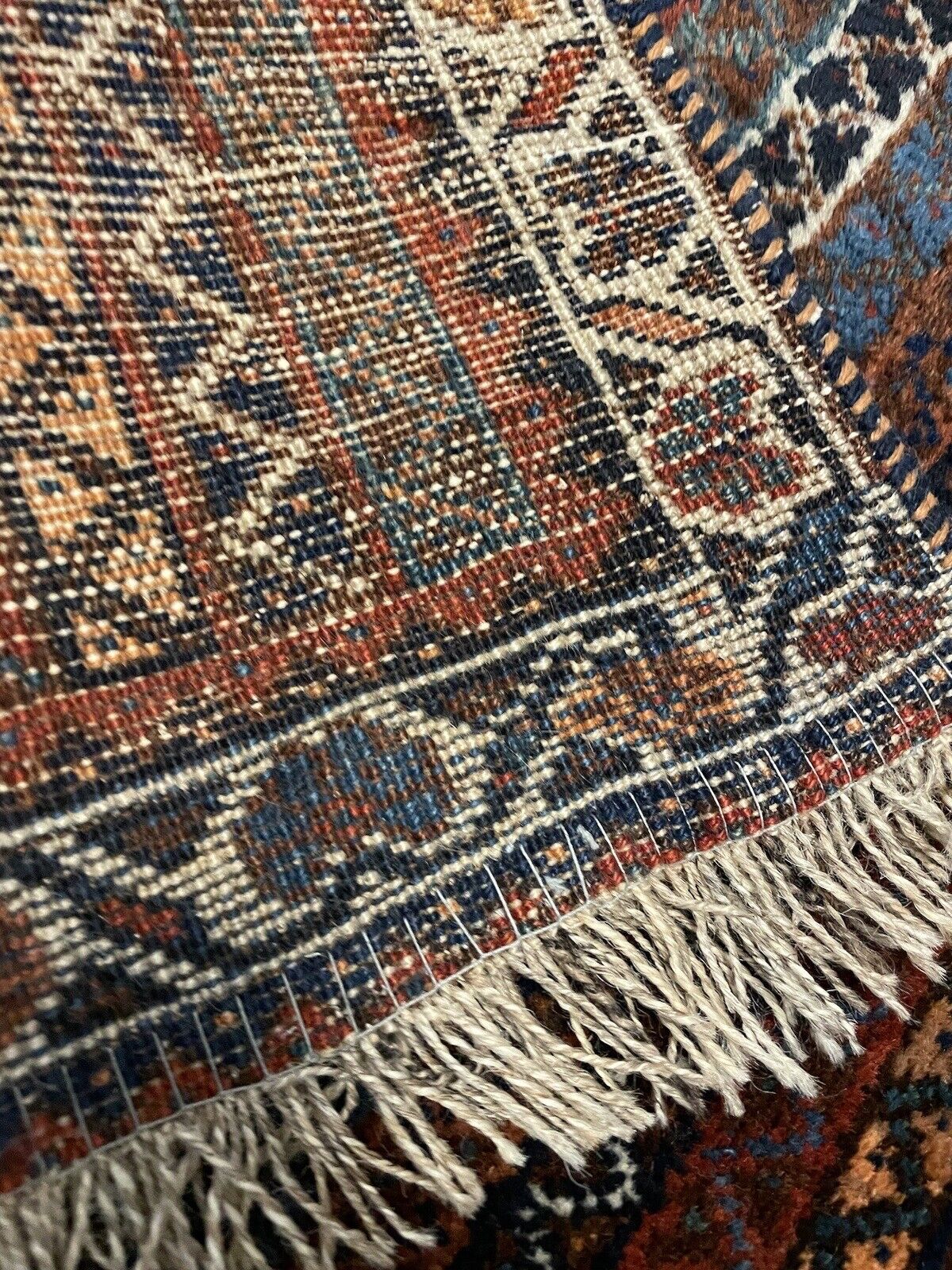 Intricate floral border with multicolored accents on a Persian rug
