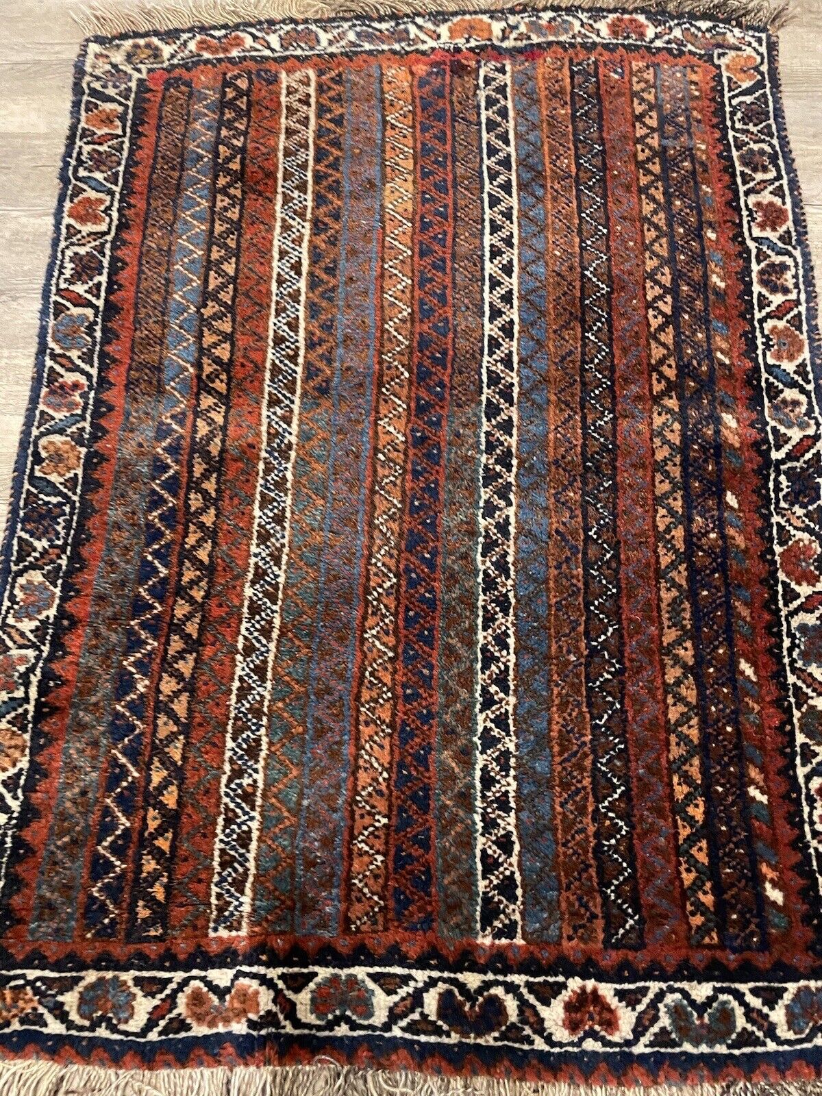 Close-up of the Persian Shiraz rug’s woven geometric patterns

