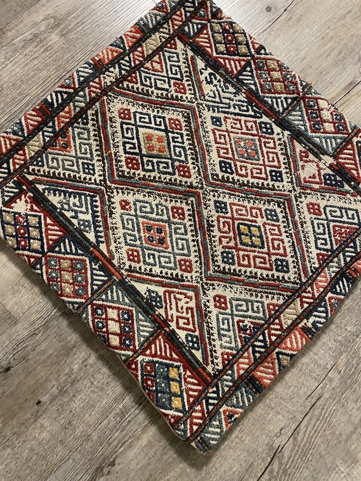 Antique Persian wool Sumak bag in red, blue, yellow, and white tones
