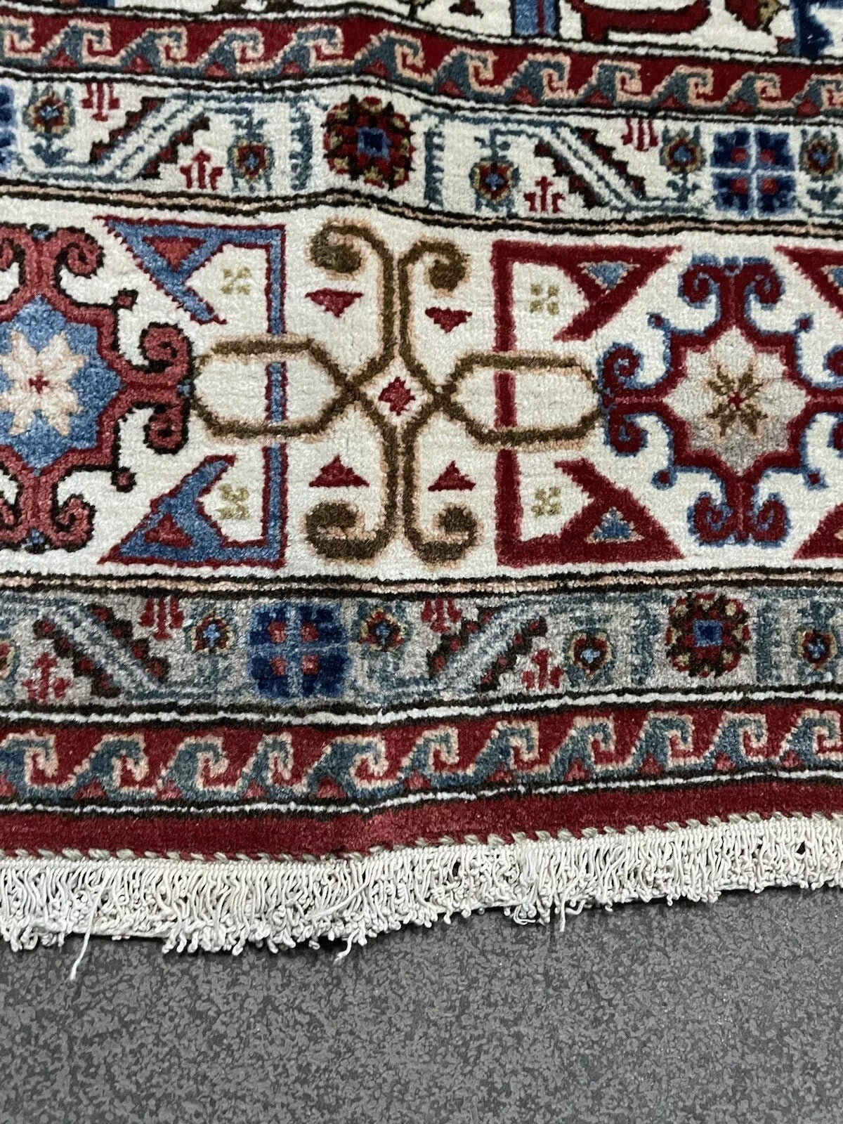 Close-up of Persian Qum rug’s central medallion design
