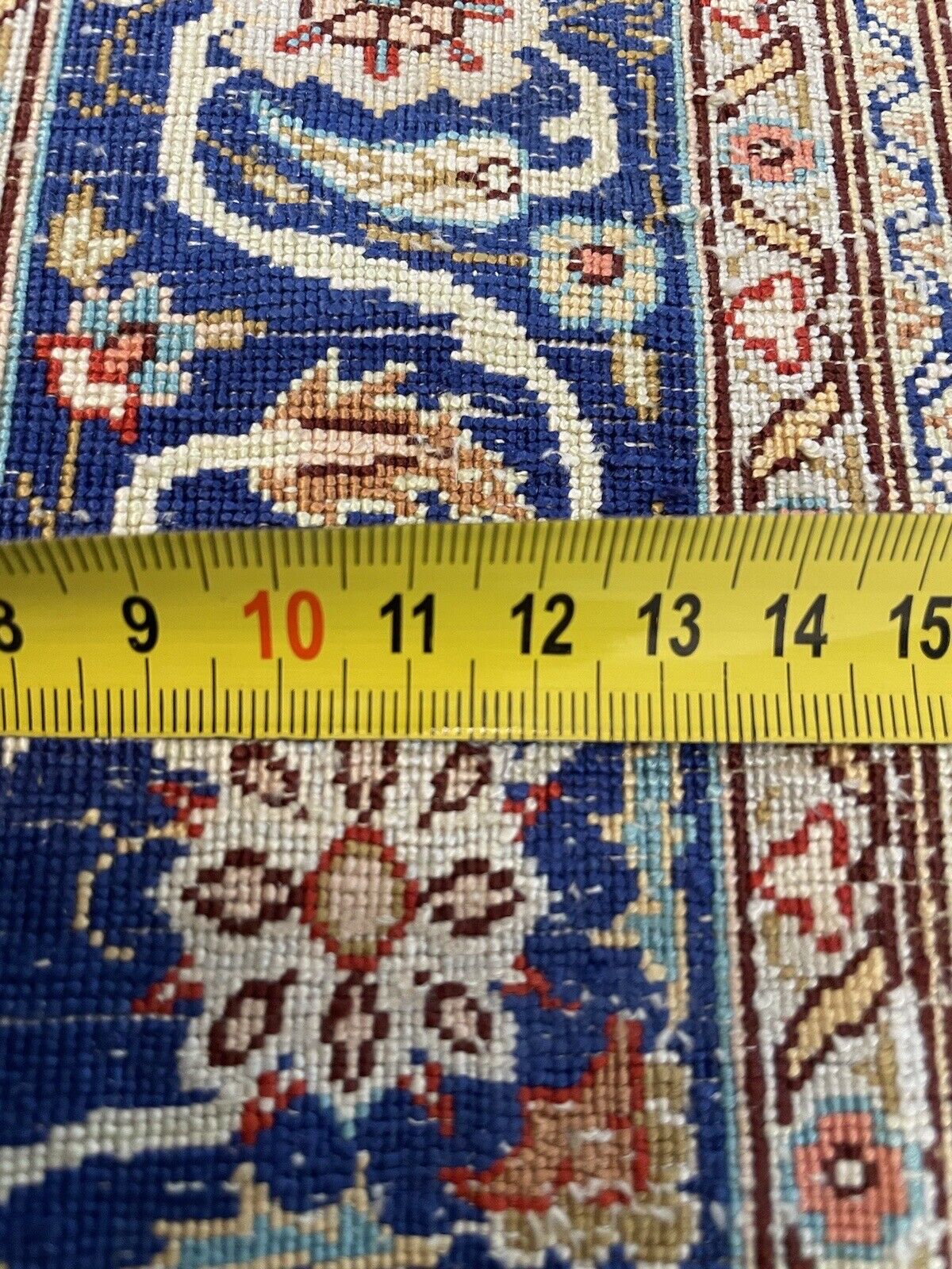 Antique Hereke rug showcasing delicate floral and geometric details
