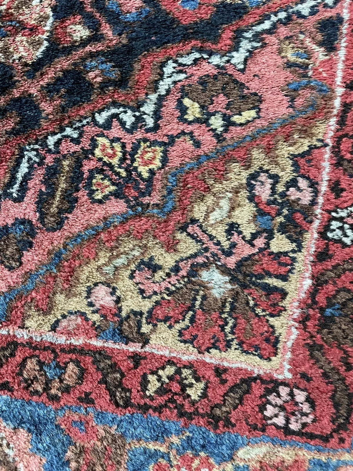 Intricate floral and geometric motifs on a Persian Bidjar rug
