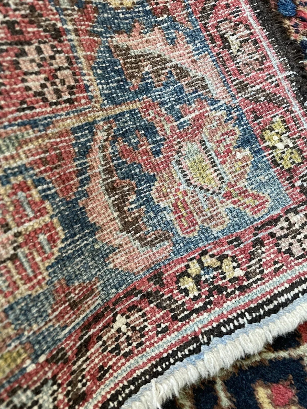 Intricately detailed antique Persian rug with a refined floral border
