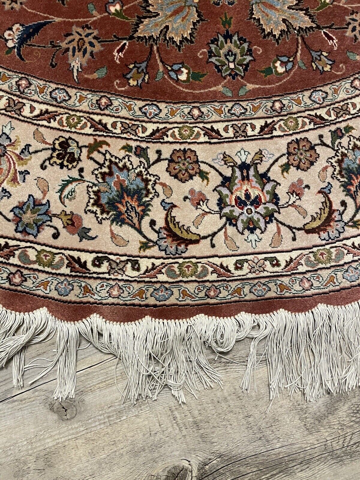 Close-up of intricate patterns on a Persian Tabriz rug
