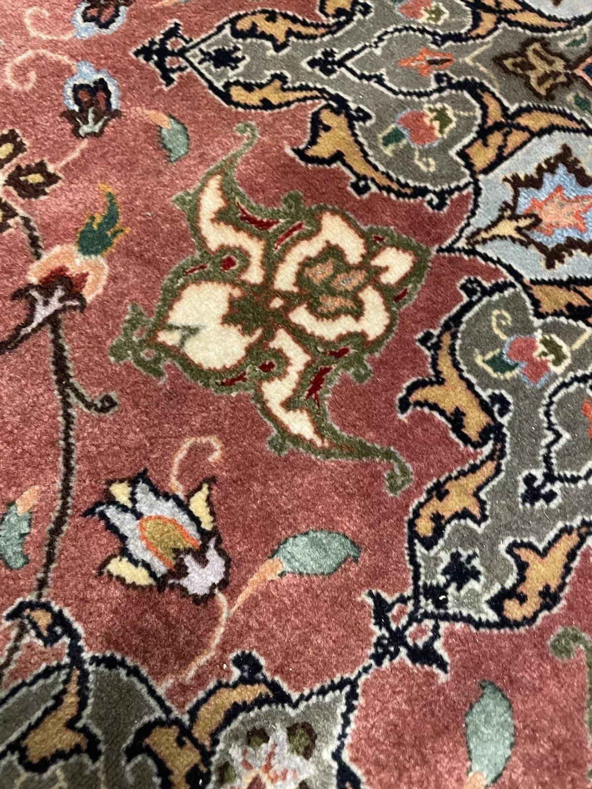 Classic Persian Tabriz rug with intricate traditional patterns
