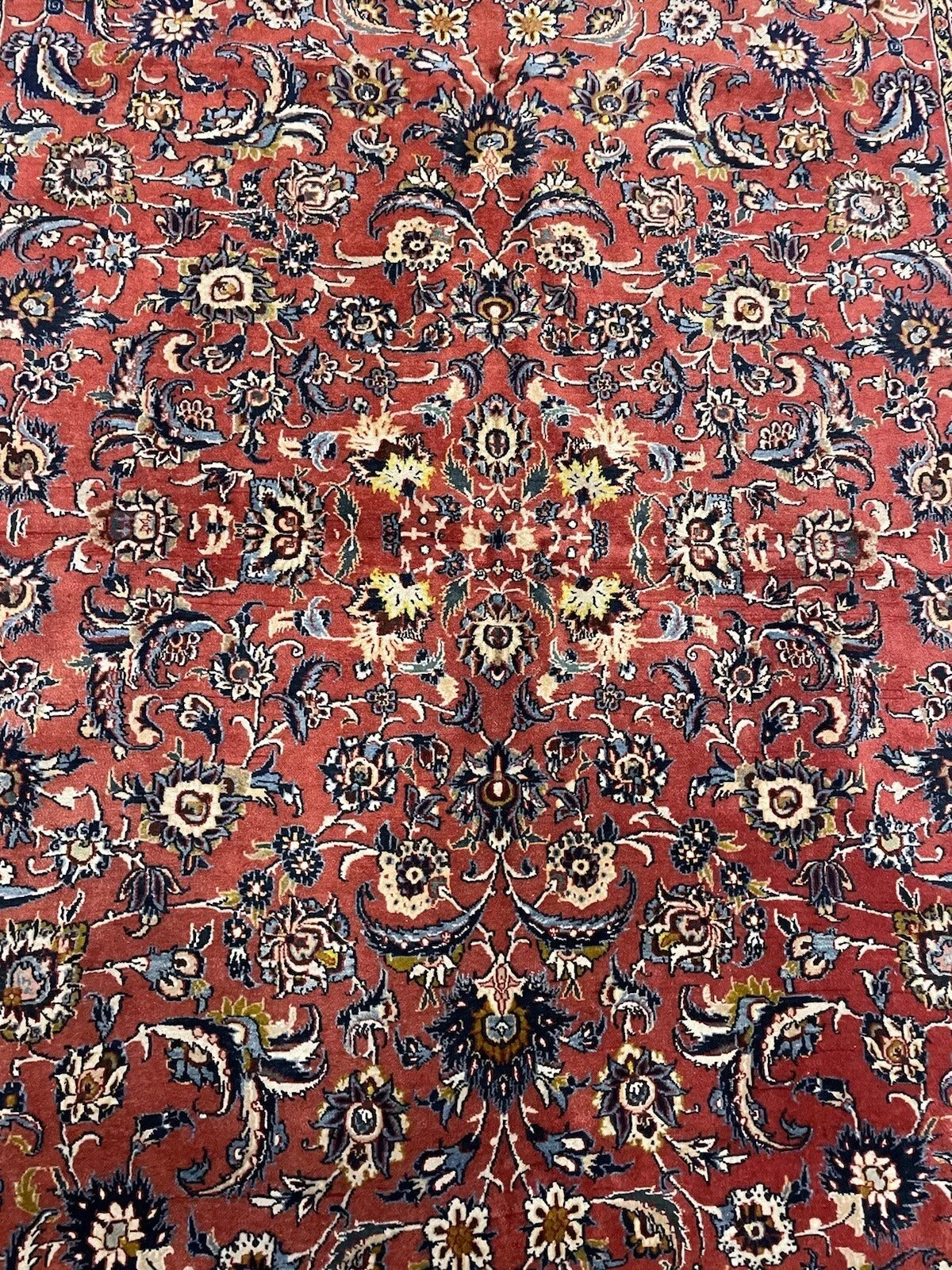 Detailed view of a vintage Persian Kashan rug's motifs

