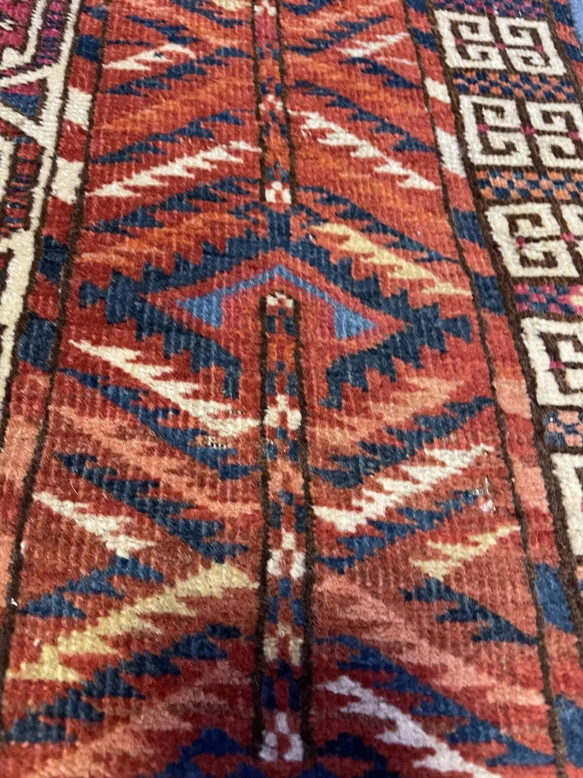 Close-up of intricate geometric motifs on a vintage Engsi rug
