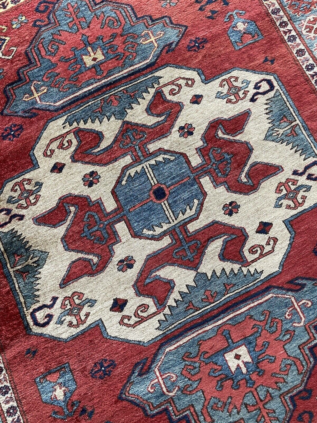 1970s handmade Caucasian Kazak rug with bold tribal motifs
