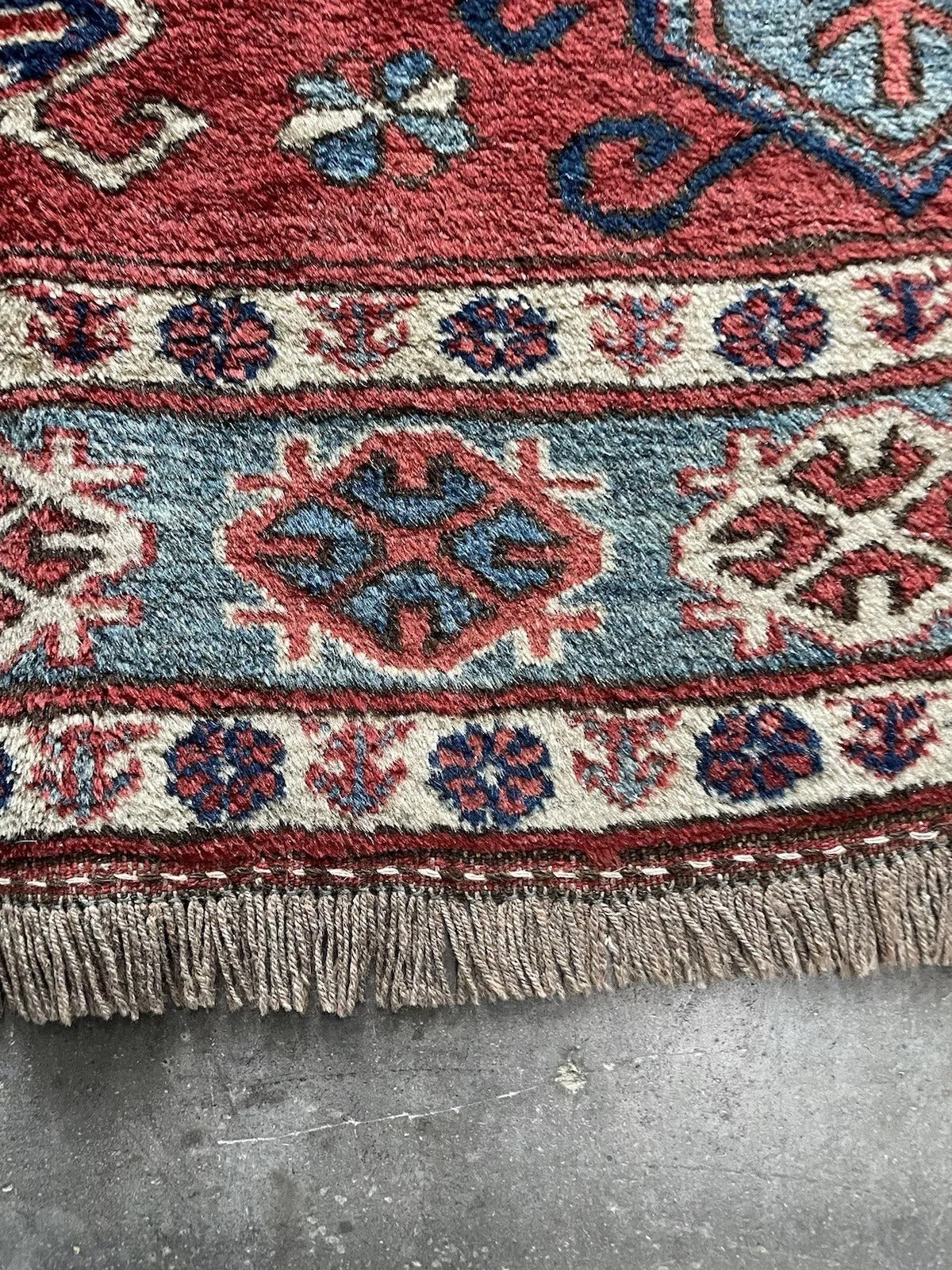 Vintage handmade Caucasian rug with geometric symbolism
