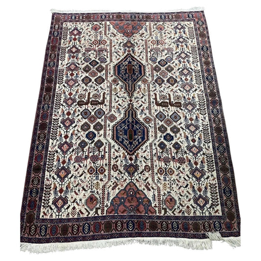 Close-up of intricate geometric patterns on a vintage Persian Afshar rug
