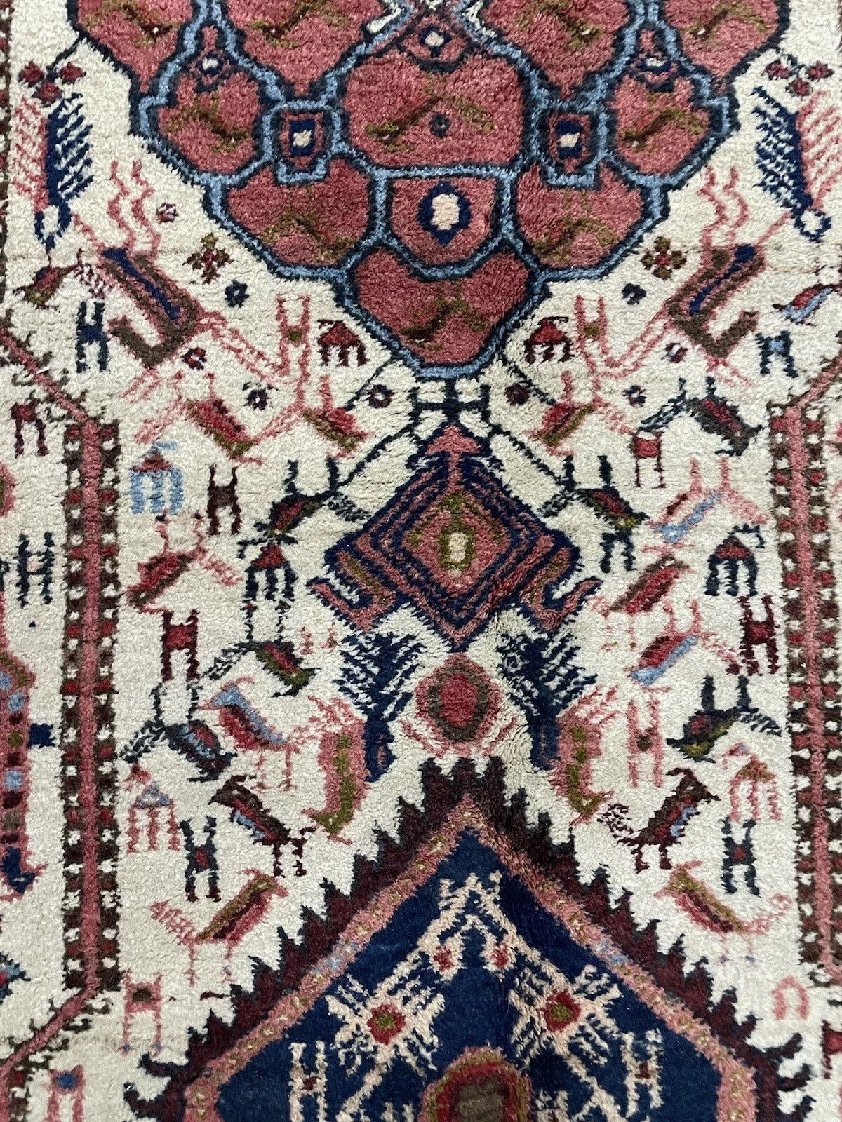 Handmade wool Afshar rug in rich red, navy blue, and earth tones
