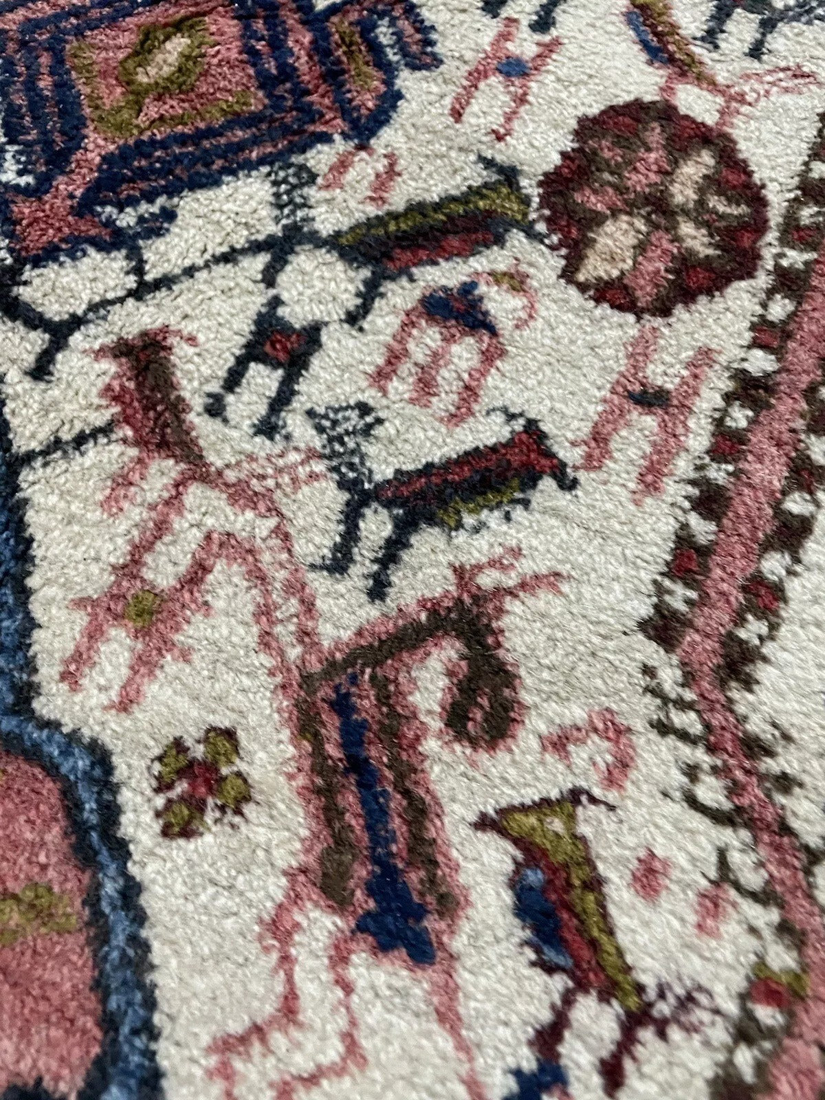 Deep red and navy blue patterns on a vintage Afshar rug
