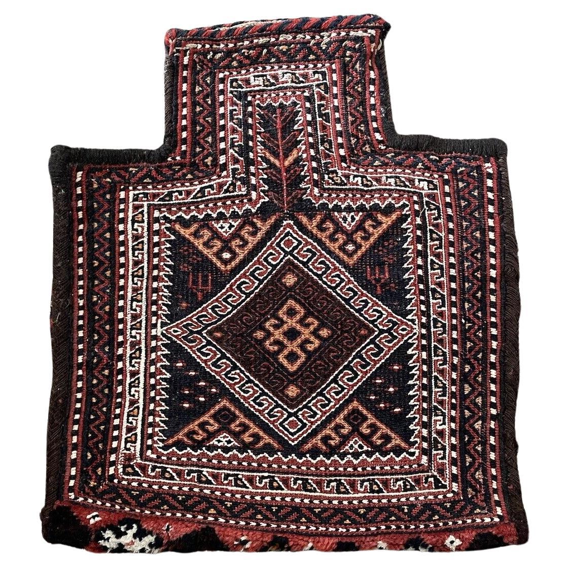 Close-up of intricate geometric patterns on a Persian Sumak salt bag
