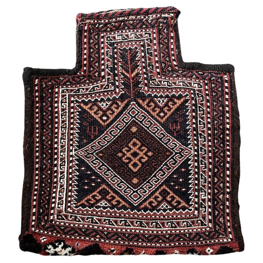 Close-up of intricate geometric patterns on a Persian Sumak salt bag
