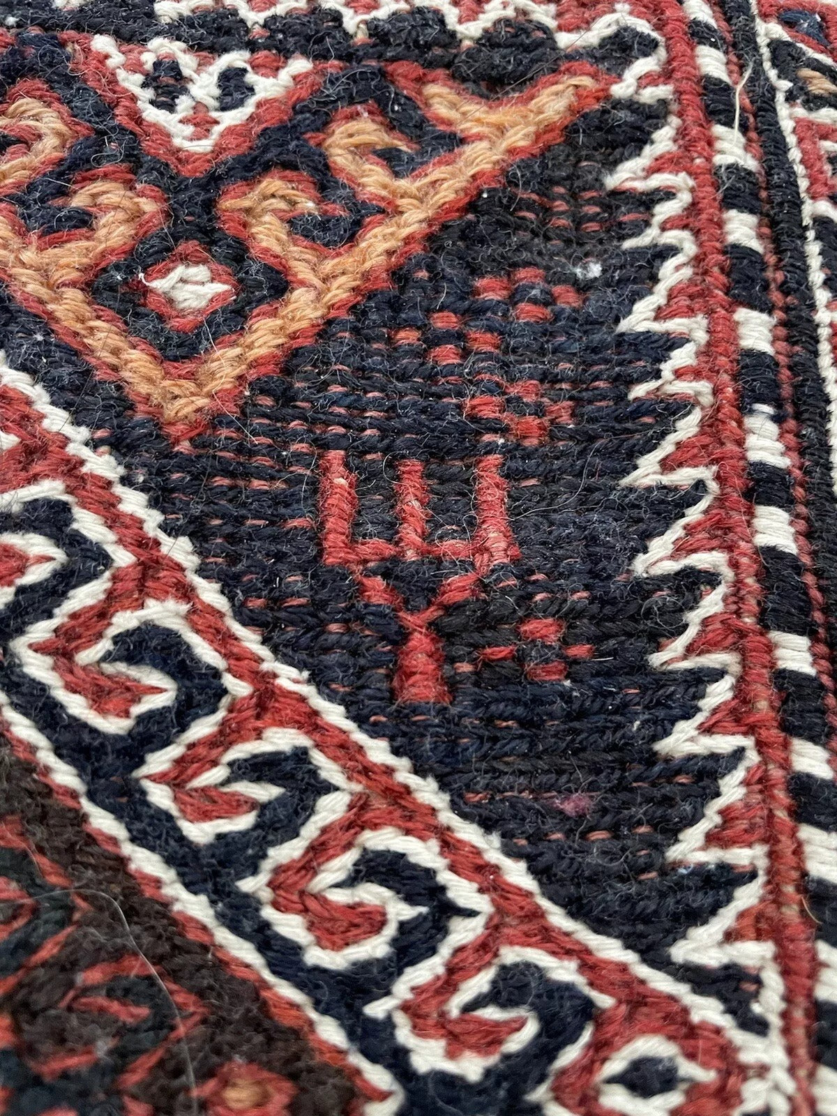 Detailed corner of an antique Persian Sumak salt bag

