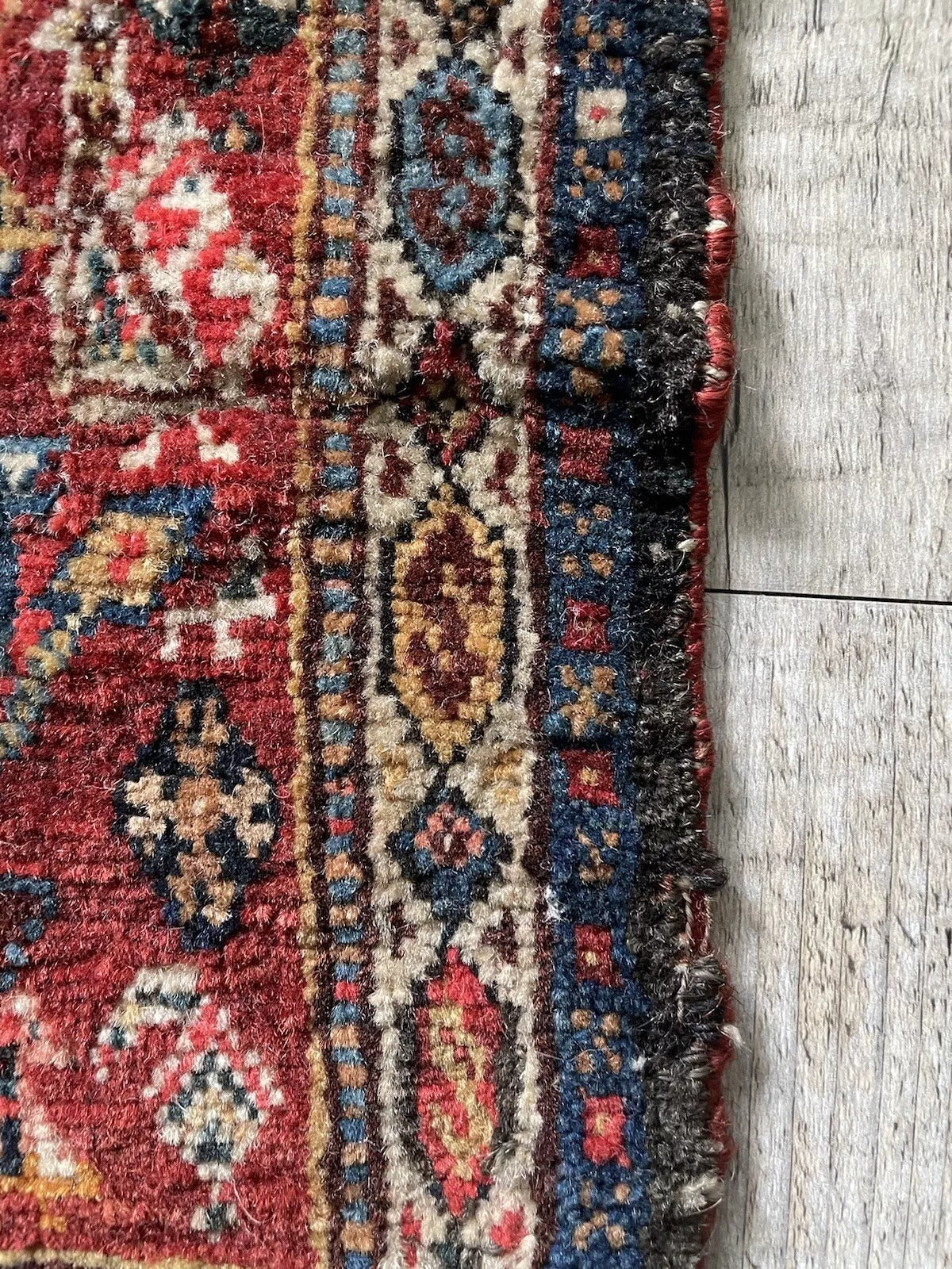 Close-up of age wear on an antique Gashkai rug
