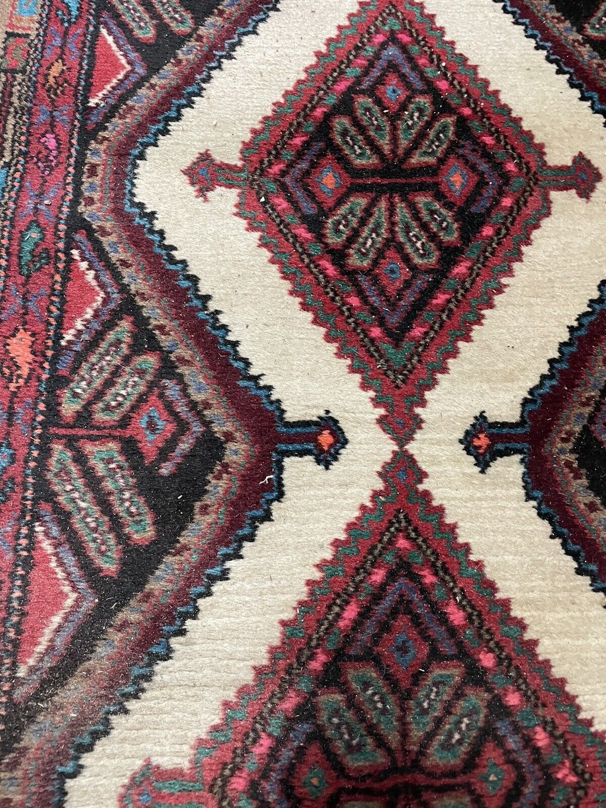 Detailed geometric diamond patterns on a handmade Hamadan rug
