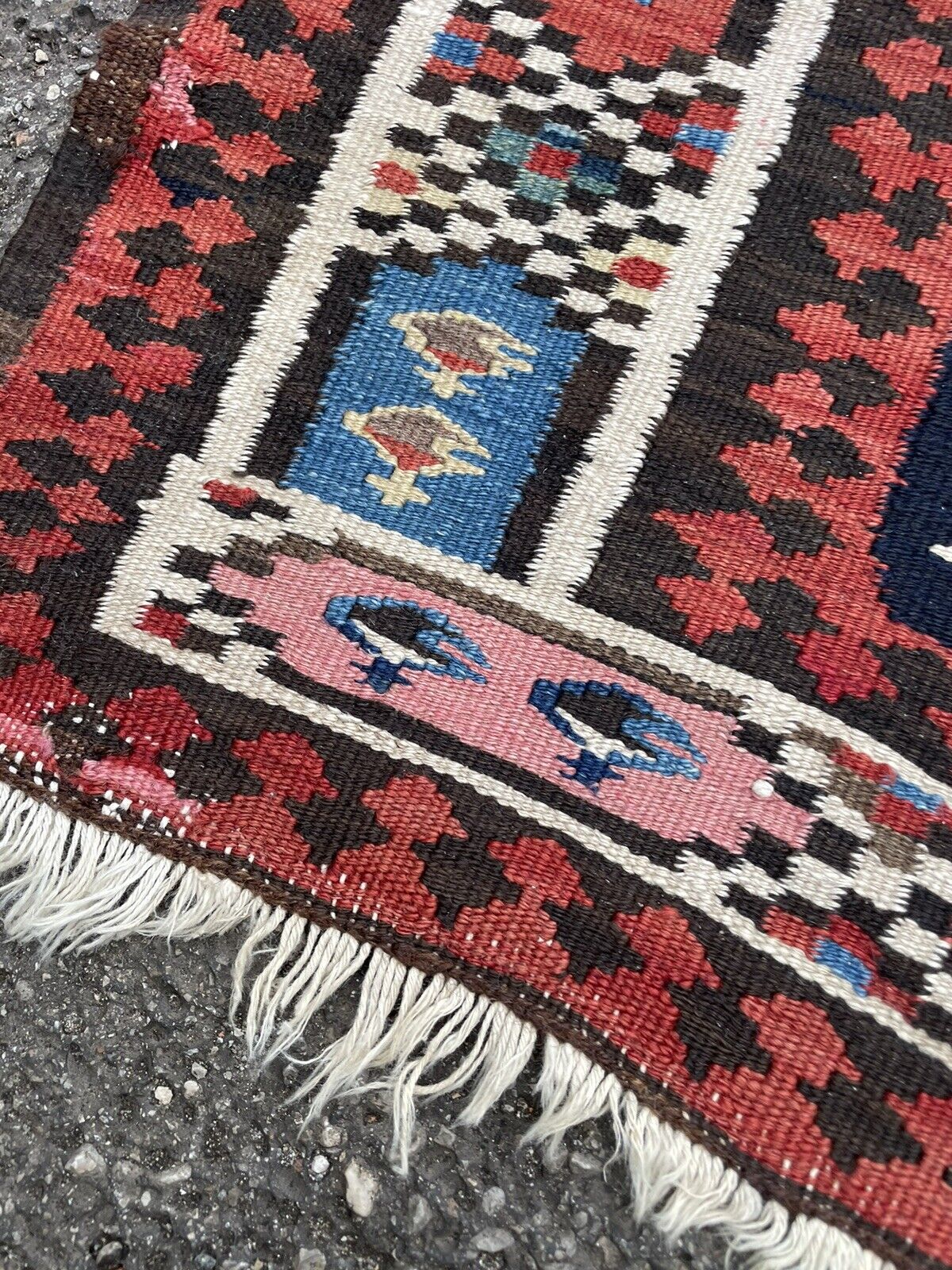 Bold red, blue, and white colors on a vintage wool kilim runner

