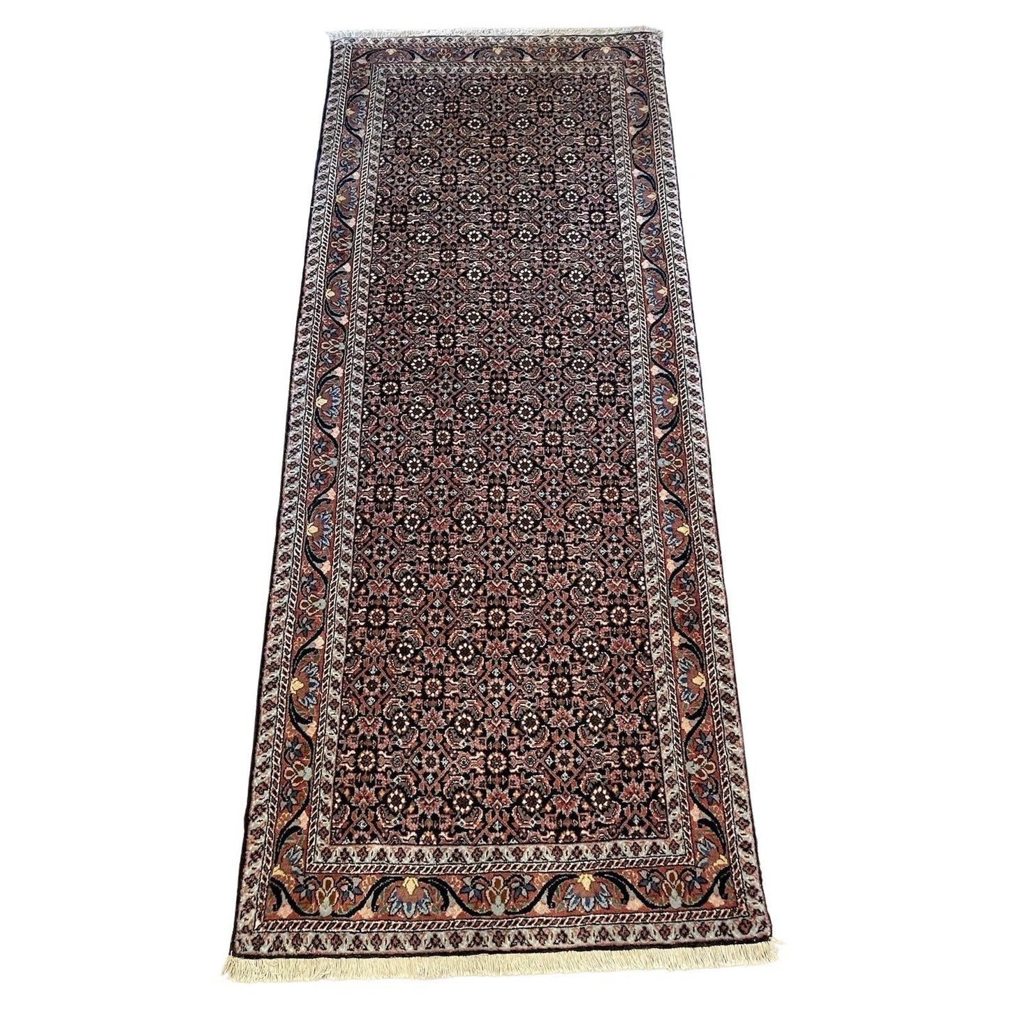 Handmade vintage Bidjar rug with intricate floral and geometric patterns
