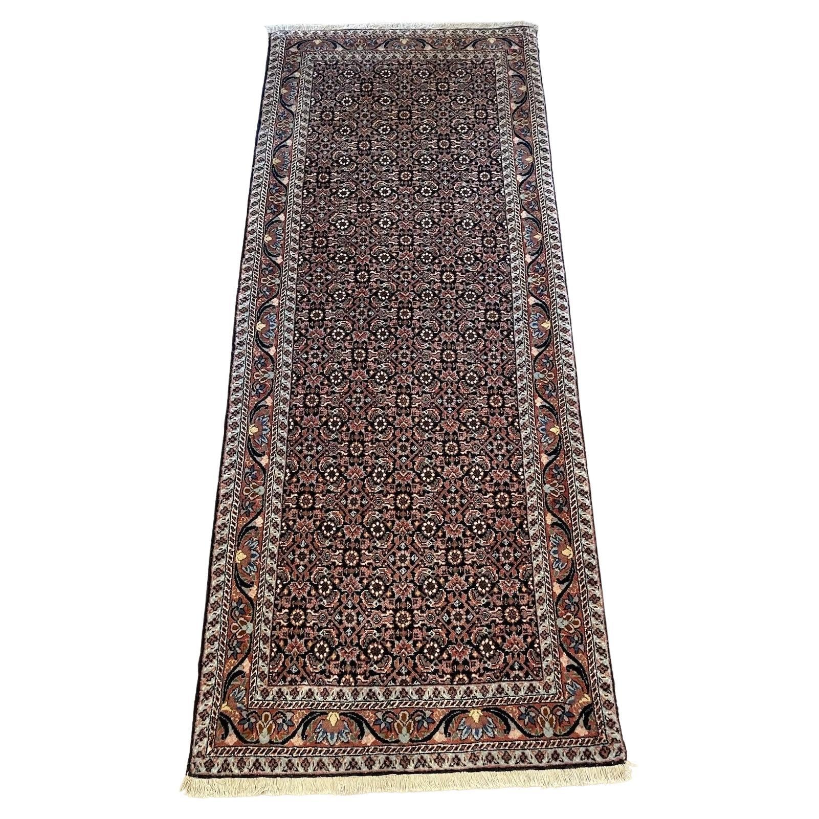 Handmade vintage Bidjar rug with intricate floral and geometric patterns
