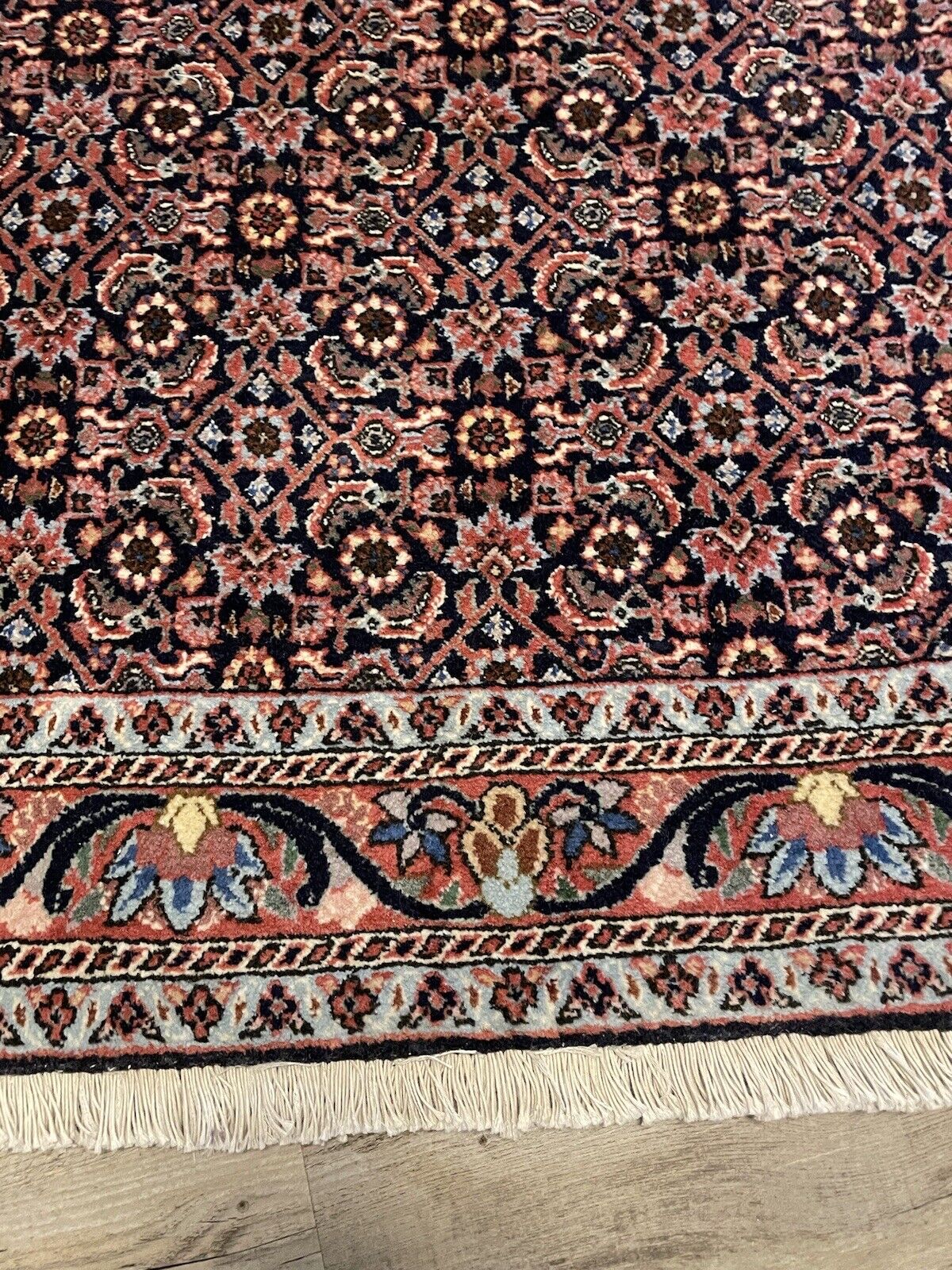 Traditional handwoven Bidjar rug in rich red, blue, and beige tones
