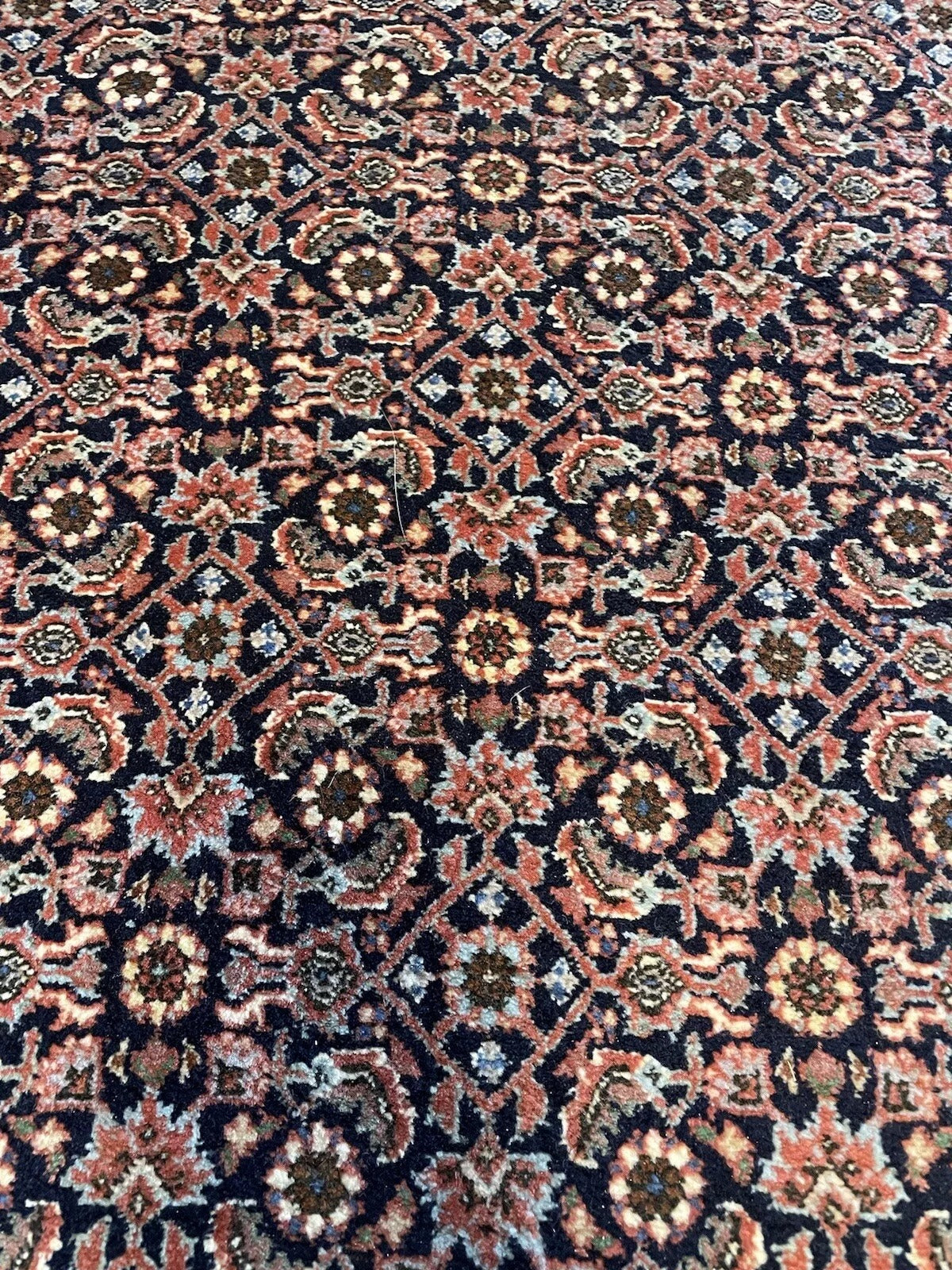 Elegant vintage runner rug in good condition with vibrant colors
