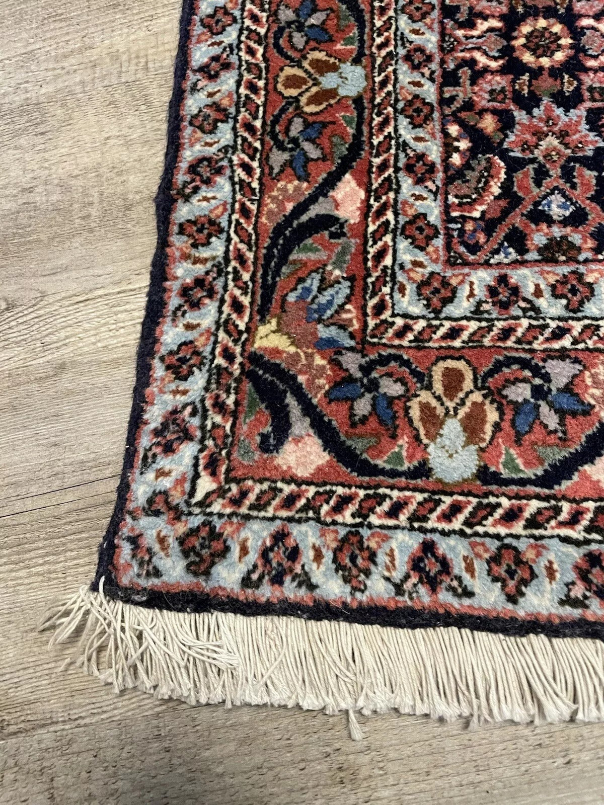 Collector’s vintage wool carpet with refined floral designs
