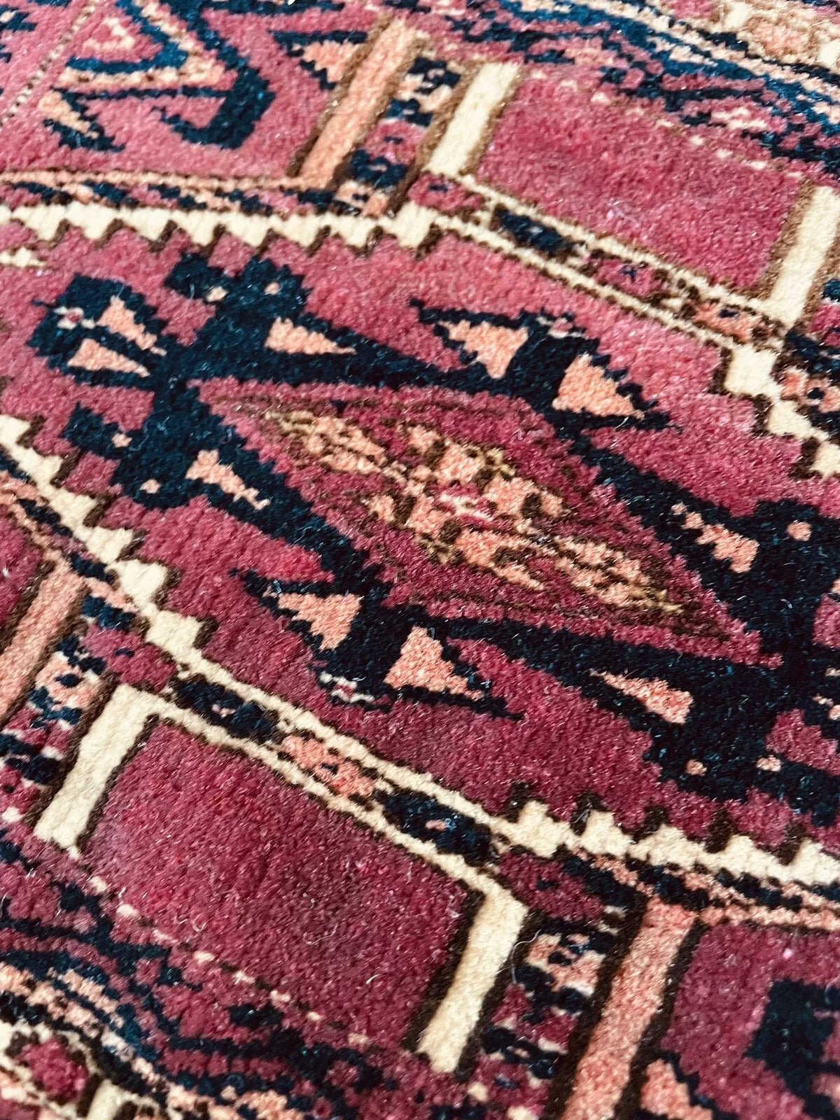 Turkmen rug featuring classic guls and central medallion design
