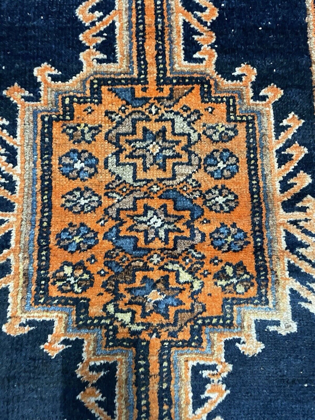 Deep blue, orange, and white hues in a 1920s Persian rug

