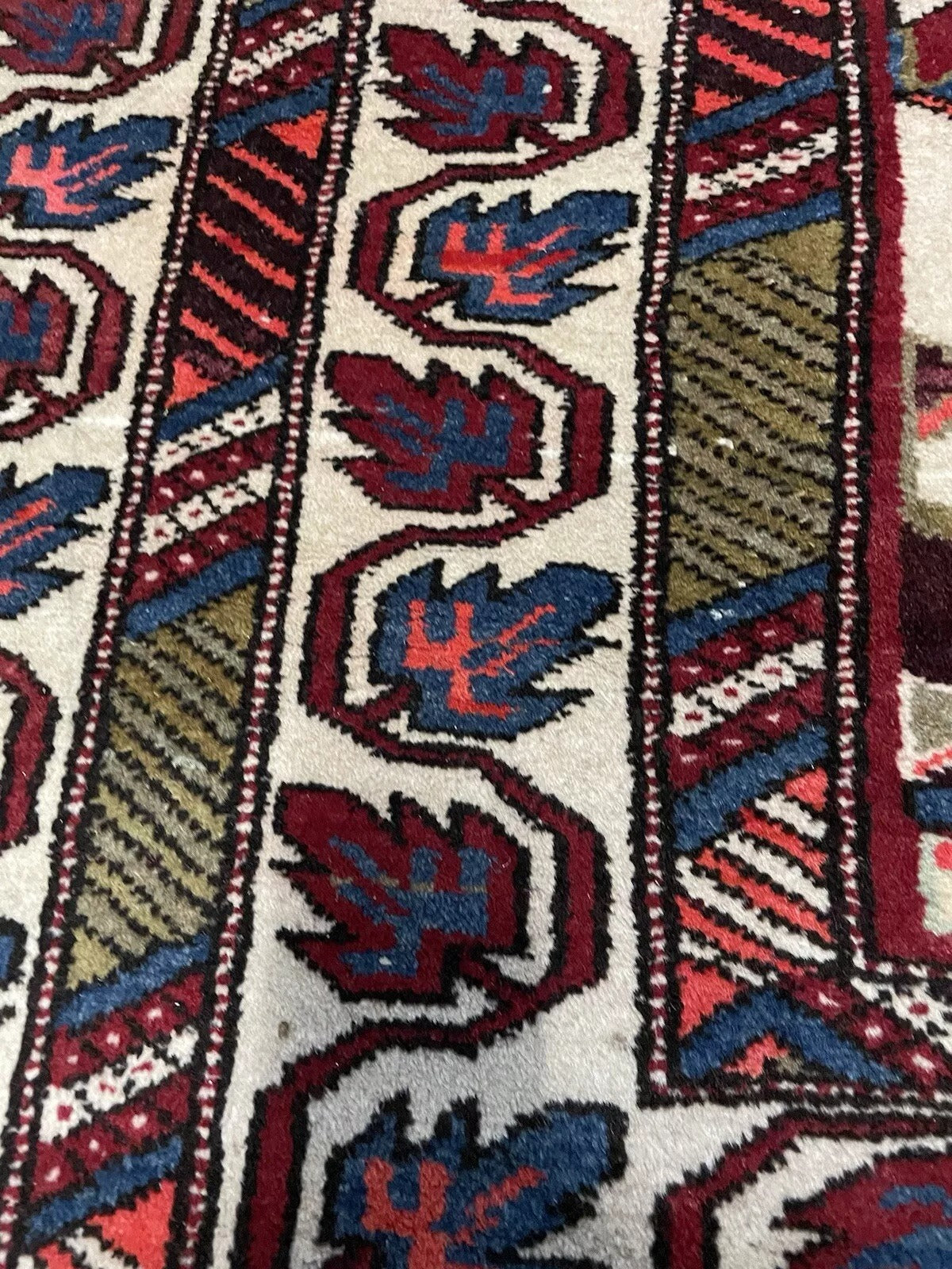Persian Hamadan rug corner showing fine wool weaving.

