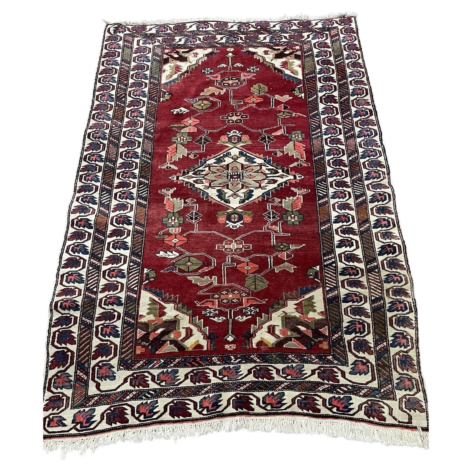 Handmade vintage Persian Hamadan rug with red field and floral motifs.

