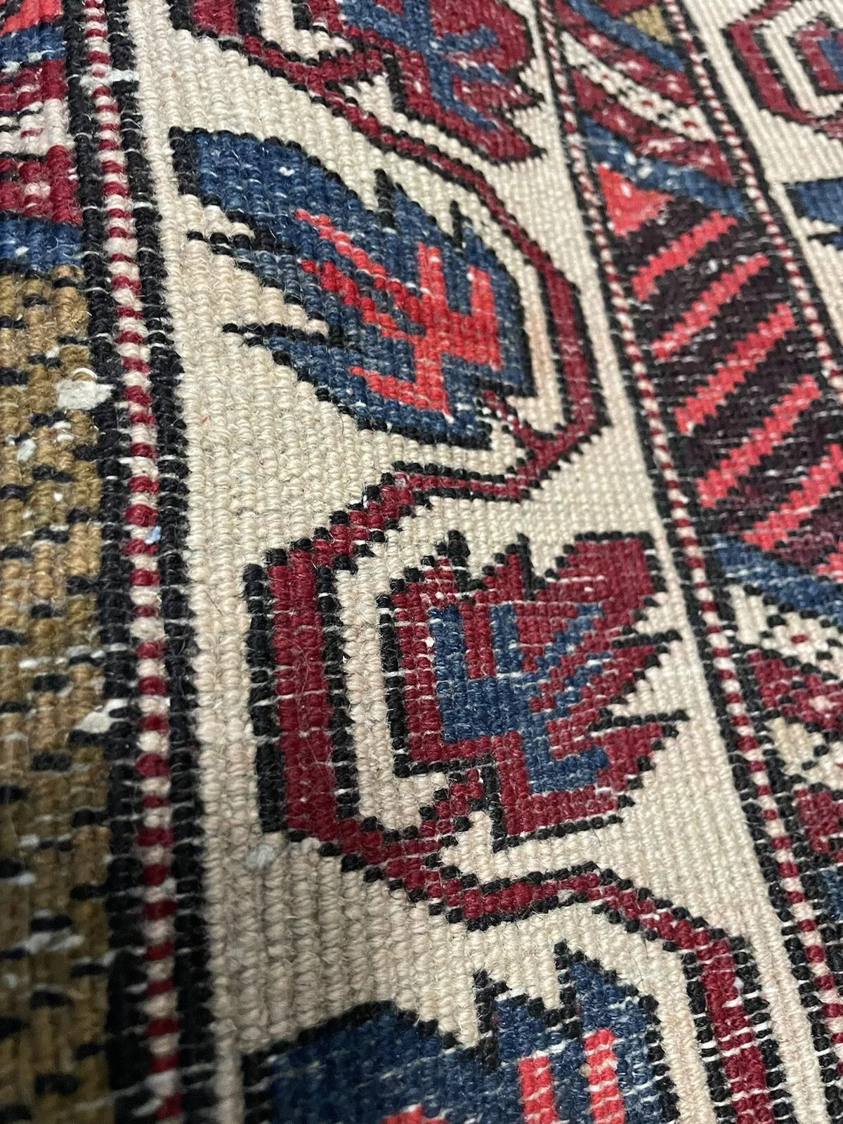 Side view of the vintage Persian rug showing soft wool texture.

